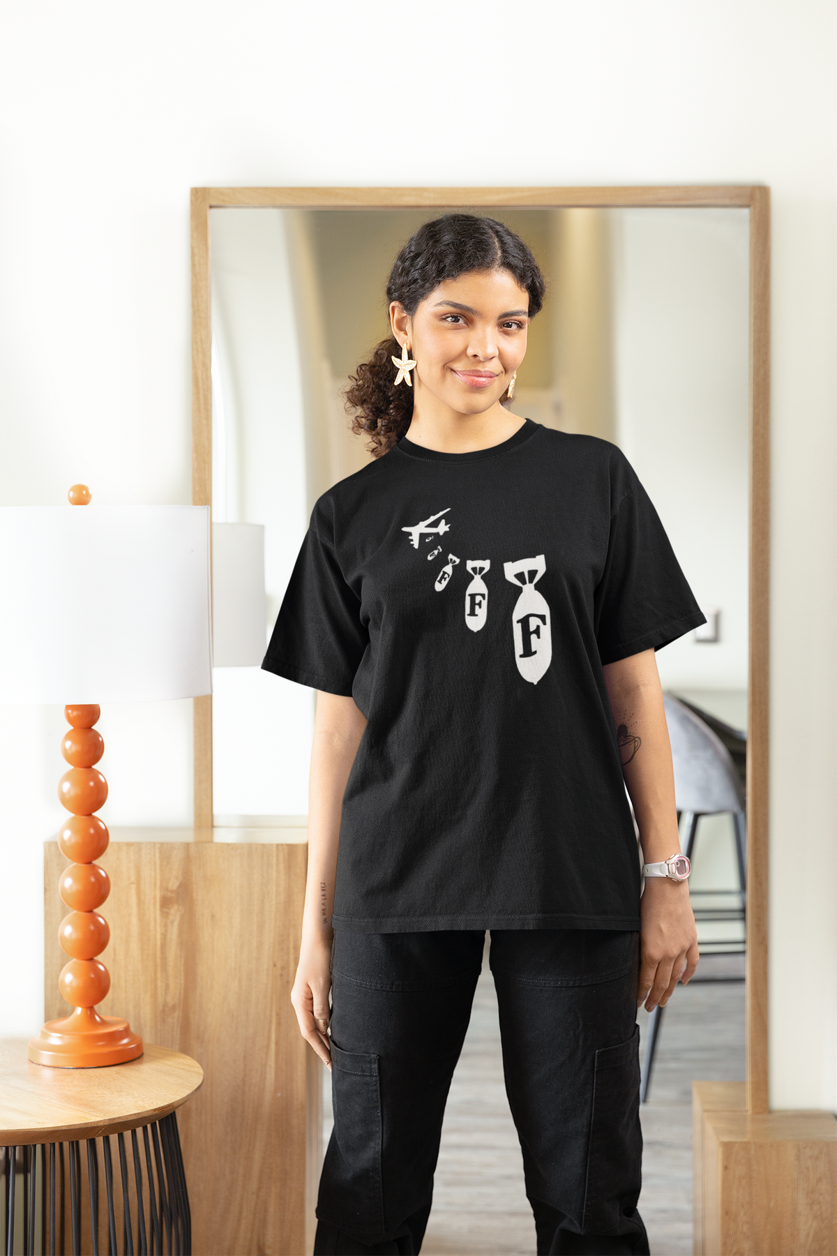 "F Bomb" tee in black, woman wearing it at a home mirror, funny sarcastic gift t-shirt