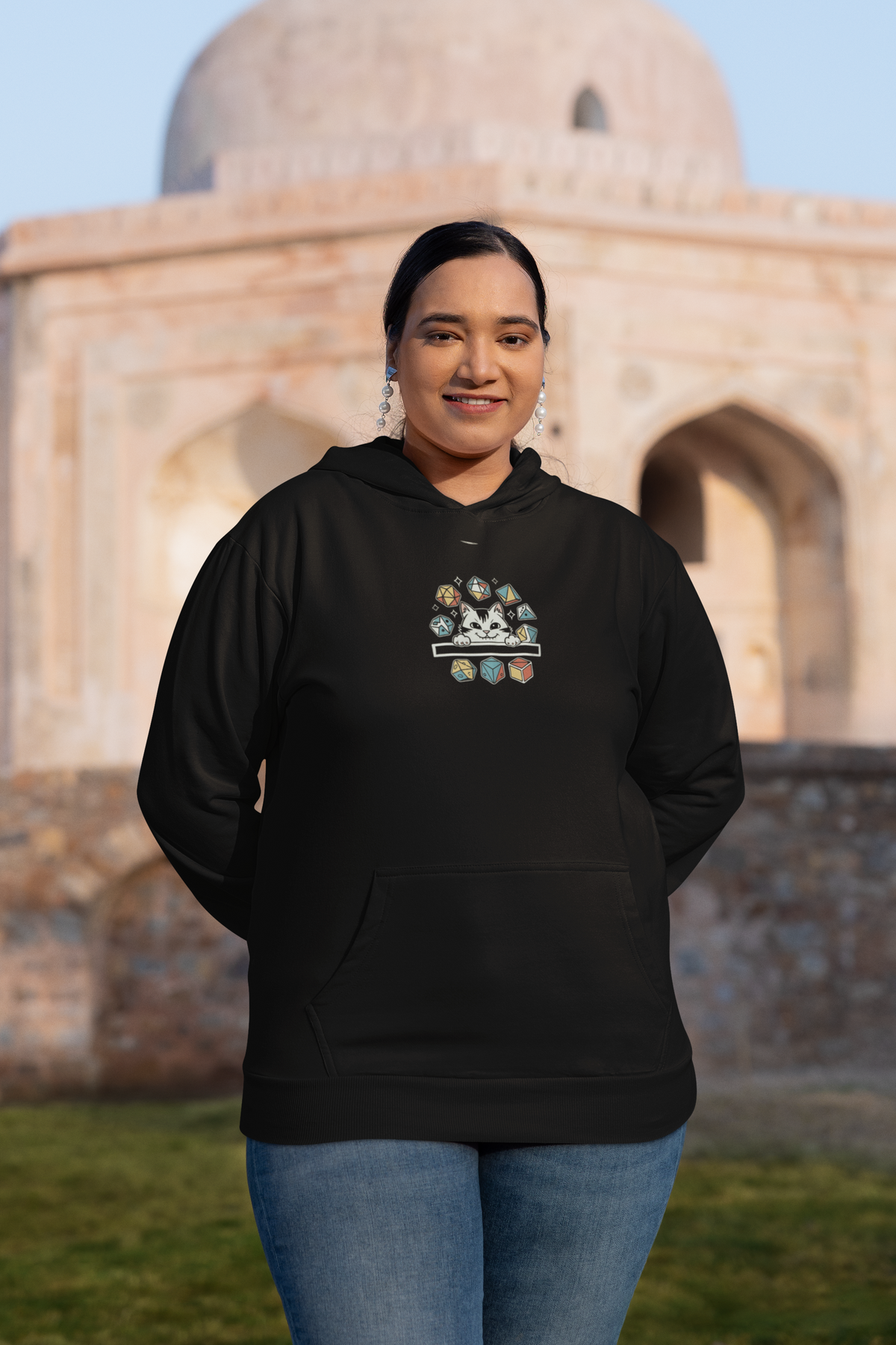 'Cat Dice' in black, woman at a historic monument, Hoodie mockup, Geekpsters