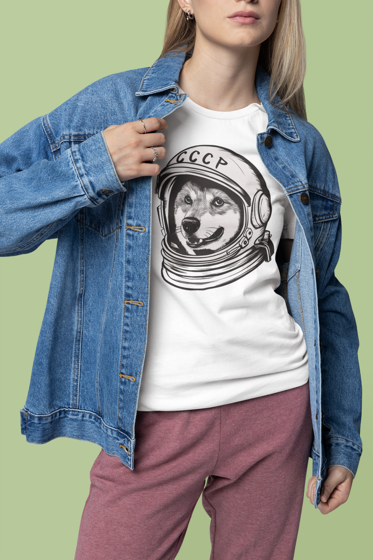 'CCCP Astronaut Dog' t-shirt in white, woman wearing it layered under a denim jacket, funny space dog tee gift