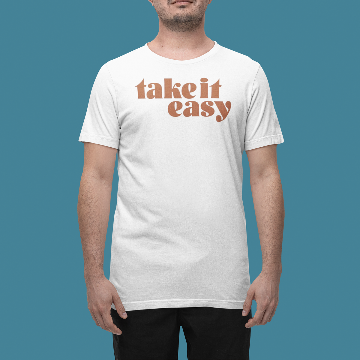 'Take it Easy' t-shirt in white, man wearing it in a studio, T-Shirt mockup, Geekpsters