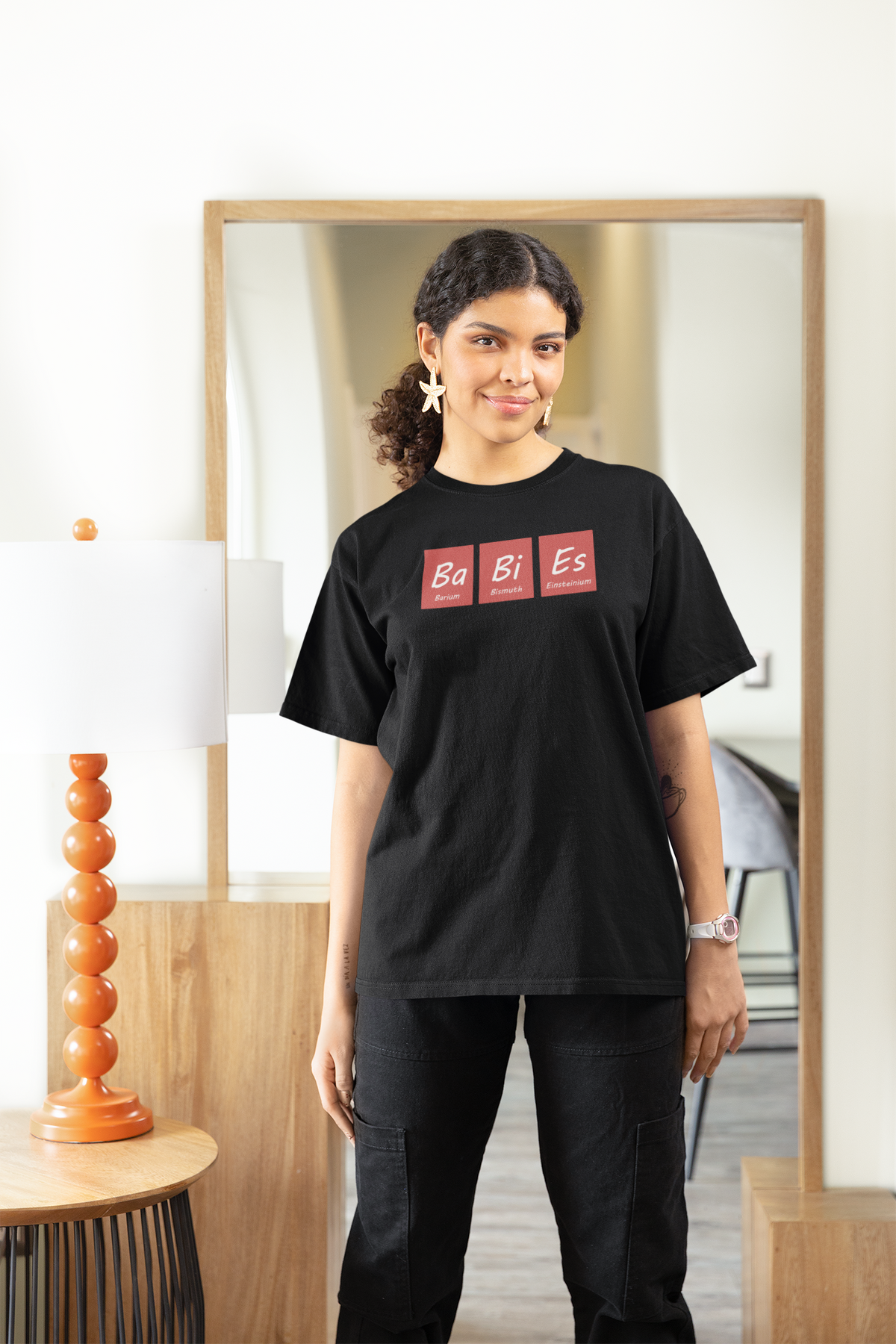 Ba-Bi-Es periodic table baby element pun women's relaxed-fit tee, model wearing it in a studio shot