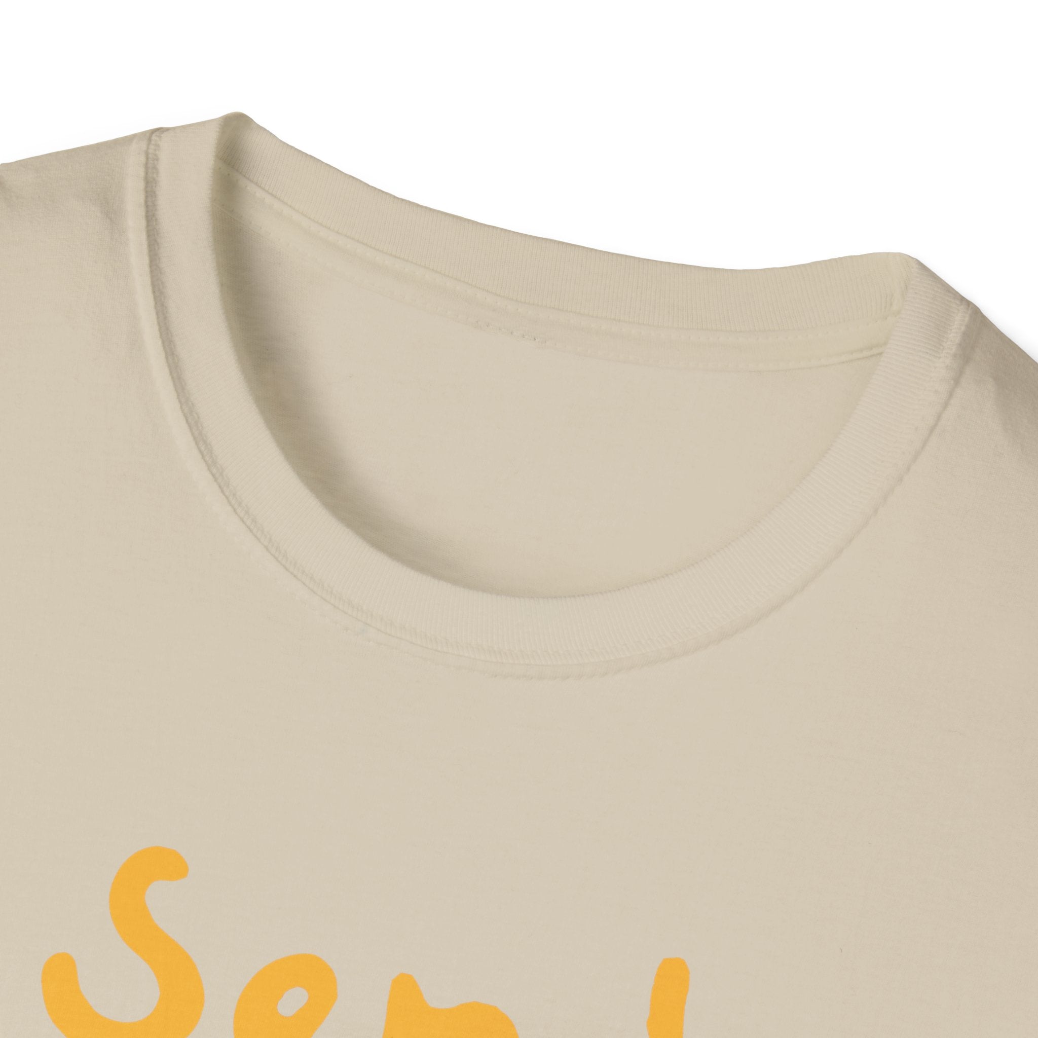Close-up of the Send Noods T-Shirt, a beige shirt with a round neckline and partial view of the yellow text design, featuring the funny phrase "Send Noods.