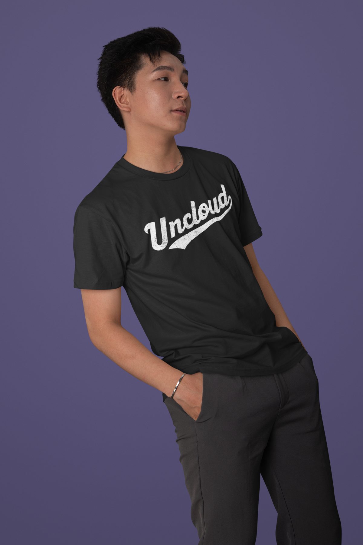 Uncloud script logo t-shirt in black, man wearing it against a purple backdrop, funny tech gift