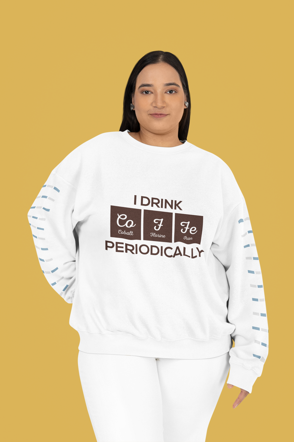 'I Drink Coffee Periodically' crewneck sweatshirt in white, curvy woman wearing it against mustard backdrop, fun gift idea