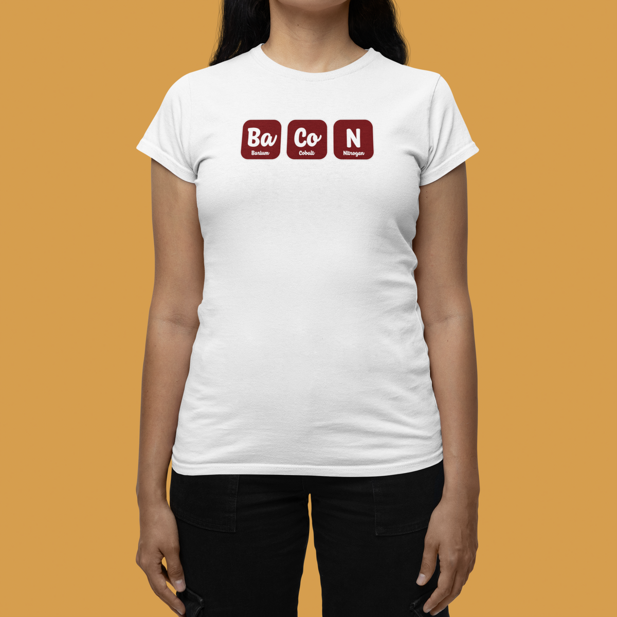 'Ba-Co-N' women's fitted t-shirt in white, woman wearing it against orange backdrop, funny foodie pun gift