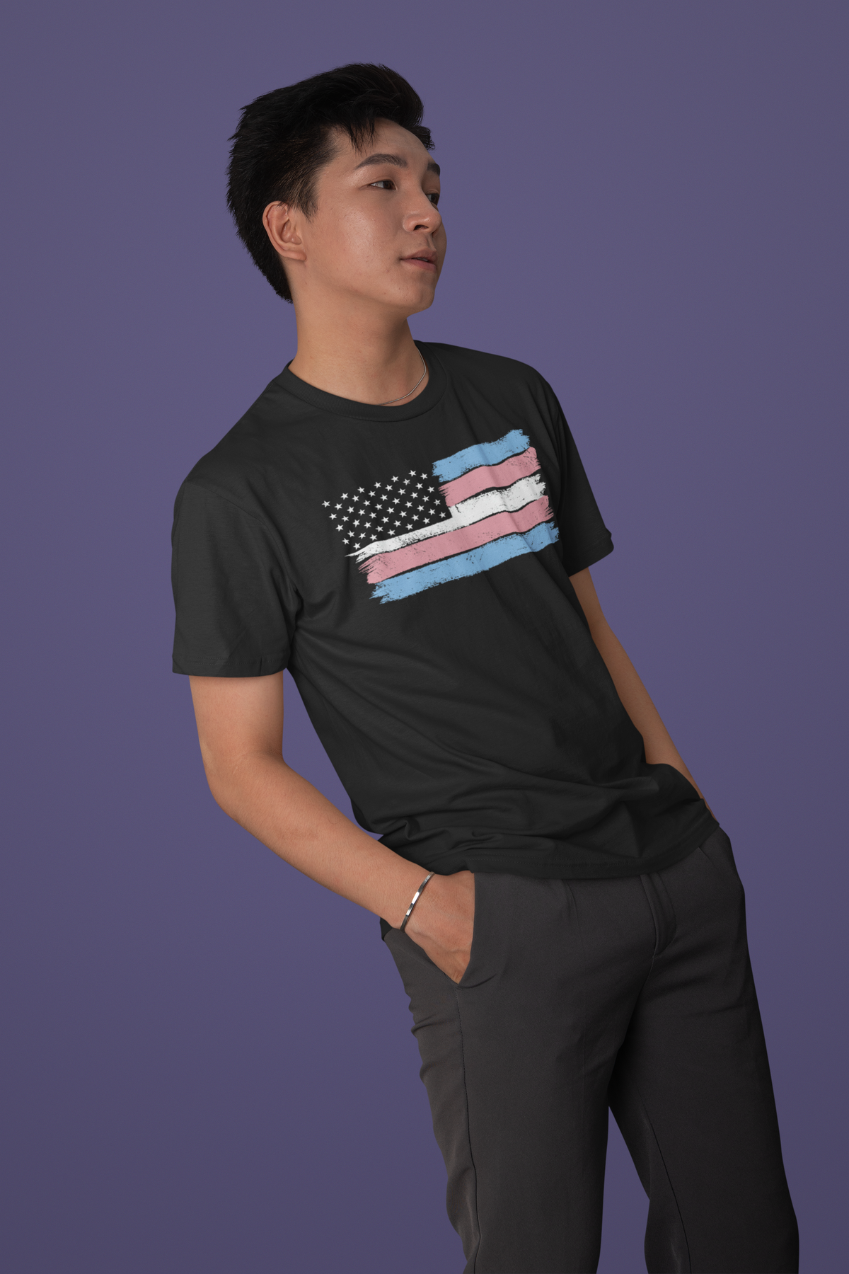 Trans pride flag t-shirt in black, man model wearing it against a purple background