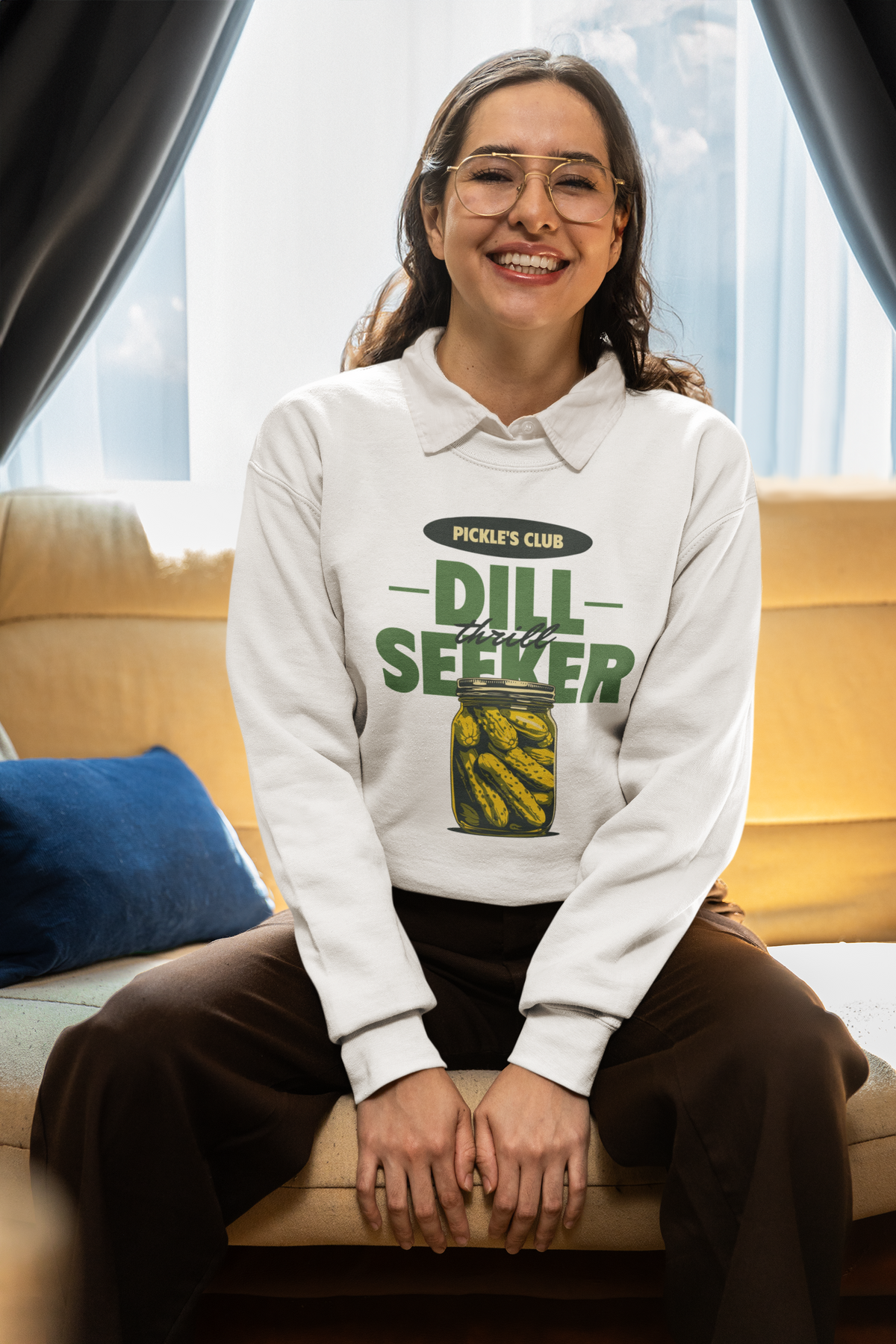 'Pickle's Club Dill Seeker' sweatshirt in white, woman wearing it seated indoors, funny pickle pun crewneck gift