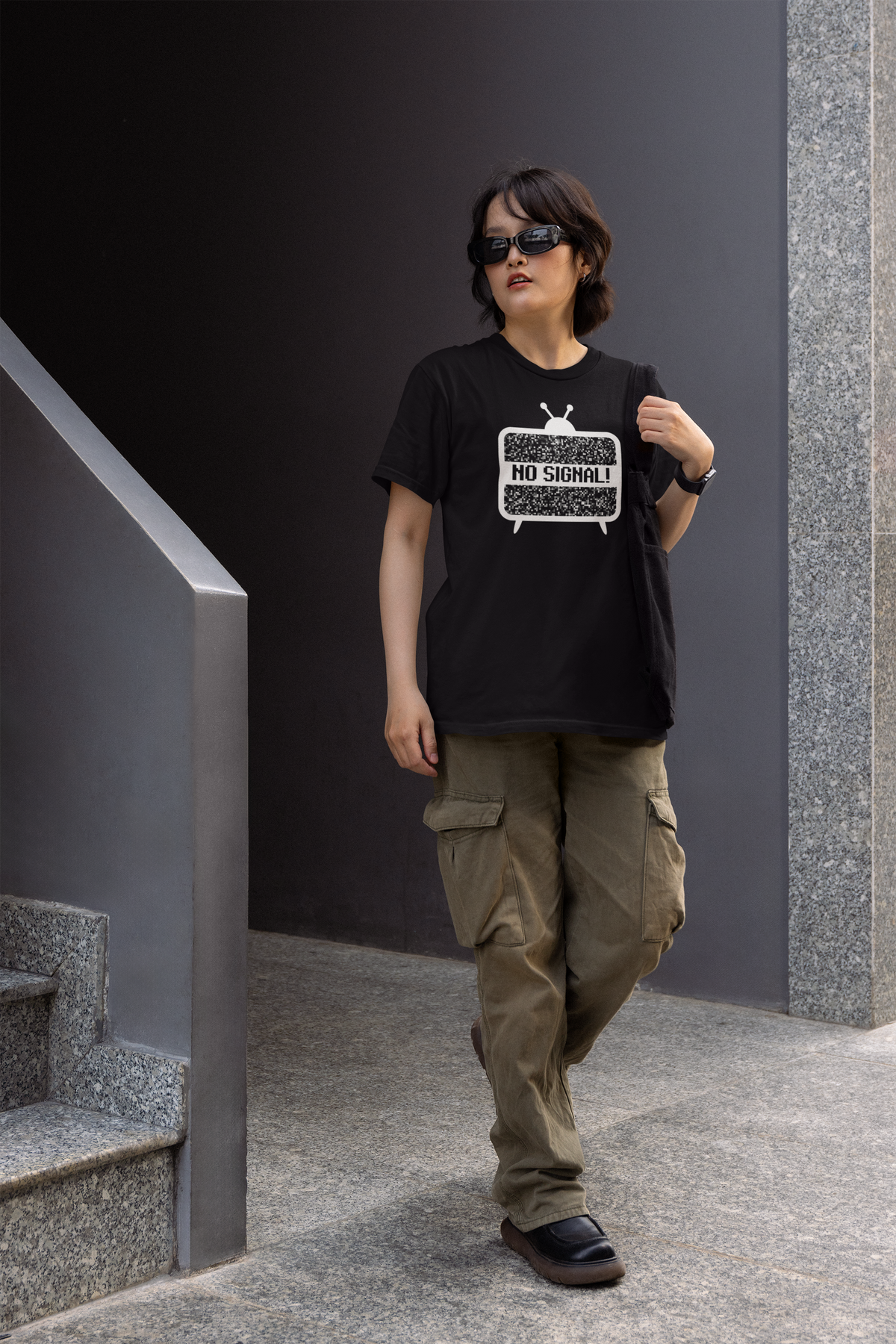 'No Signal' women's fitted t-shirt in black, woman wearing it outdoors on stairs, funny retro TV gift