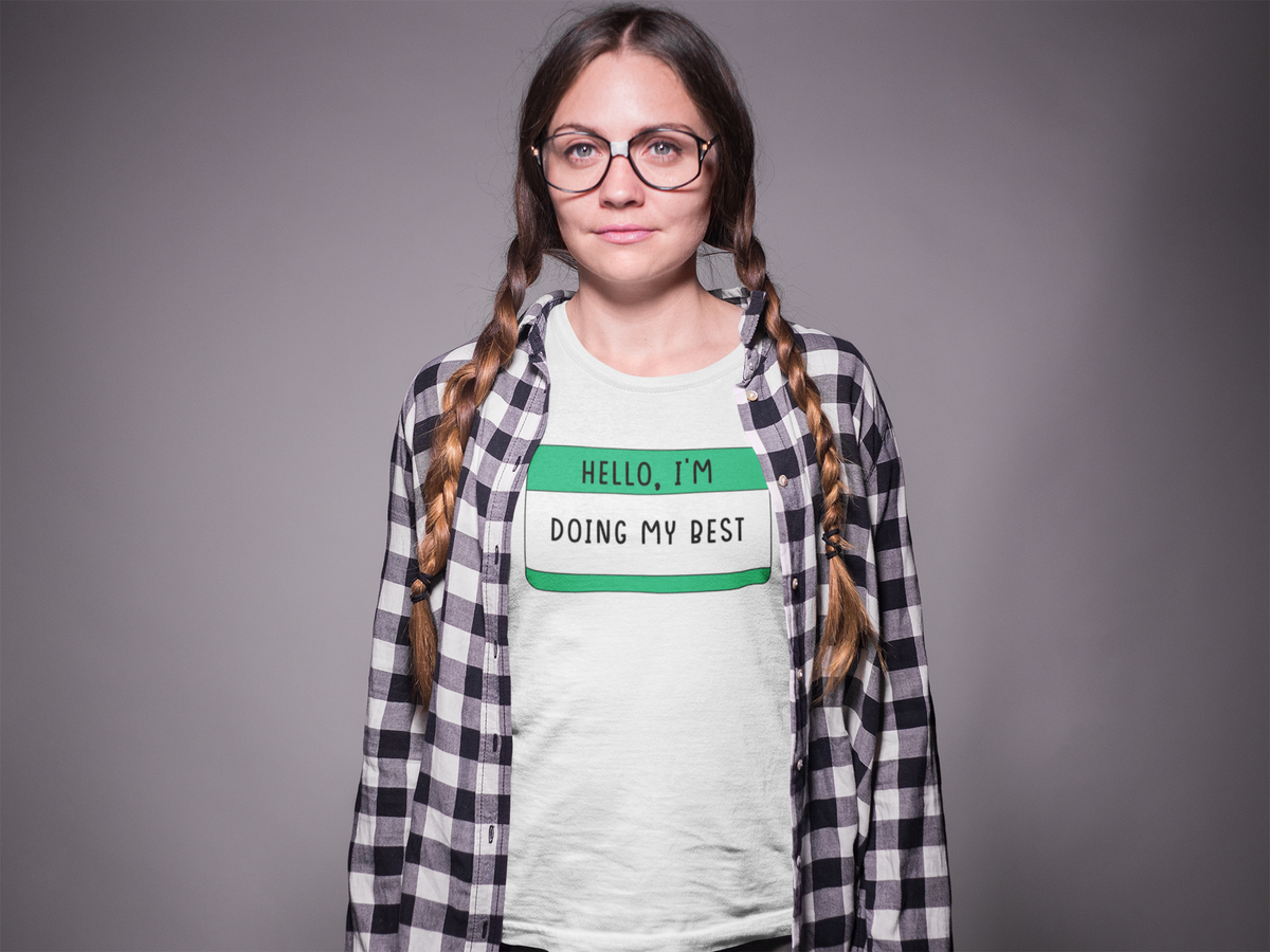 Hello I'm Doing My Best name tag T-shirt in white, woman with braids wearing it, motivational gift tee