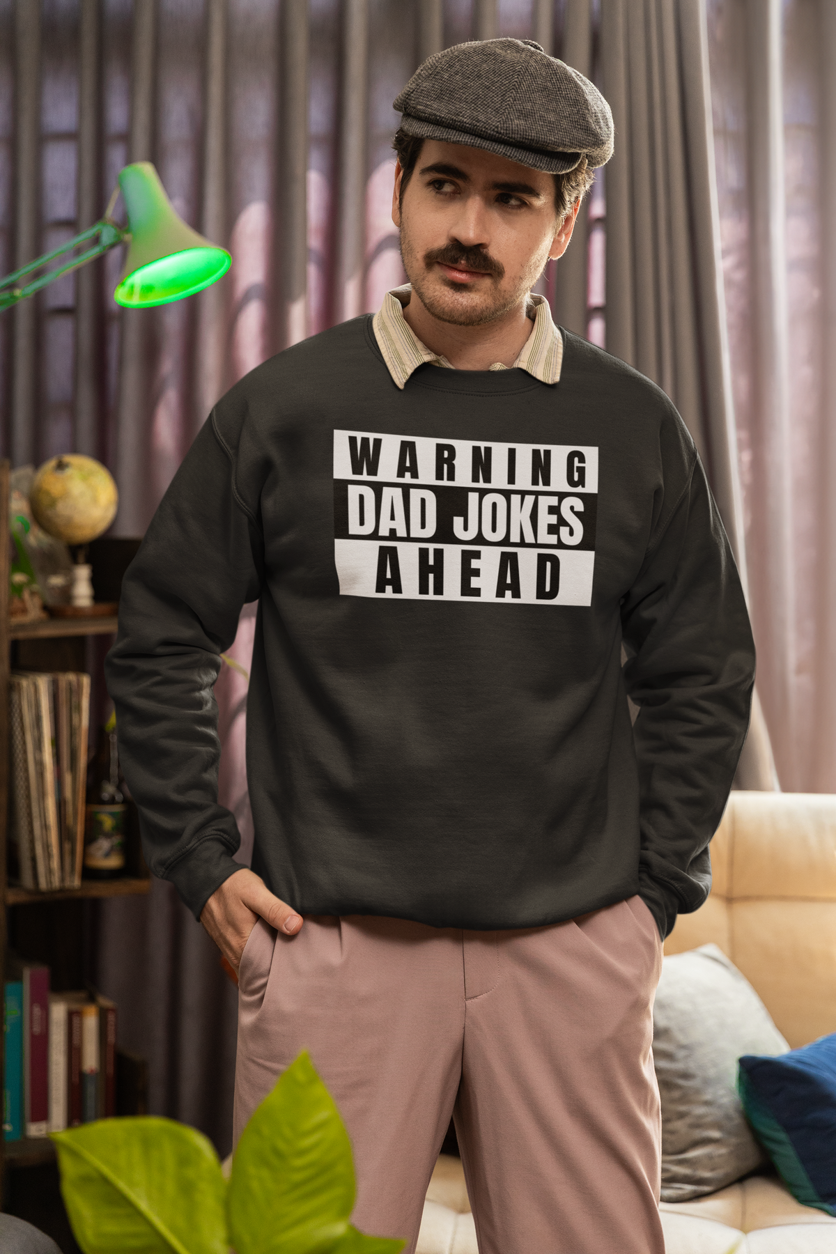 'Warning Dad Jokes Ahead' sweatshirt in black, man wearing flat cap indoors, funny dad joke gift