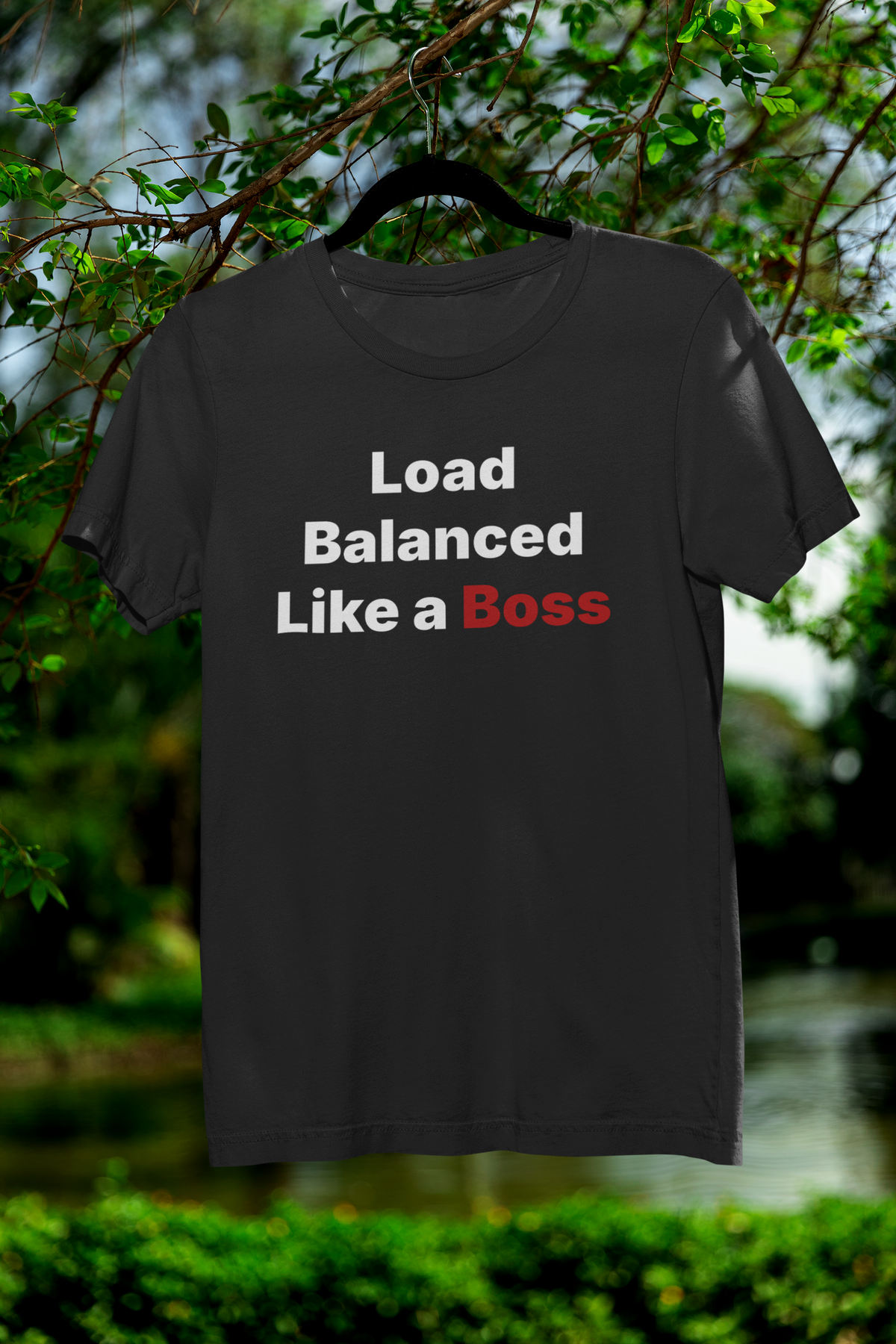 'Load Balanced Like a Boss' t-shirt in black, hanging outdoors in tree, funny gift for network engineers