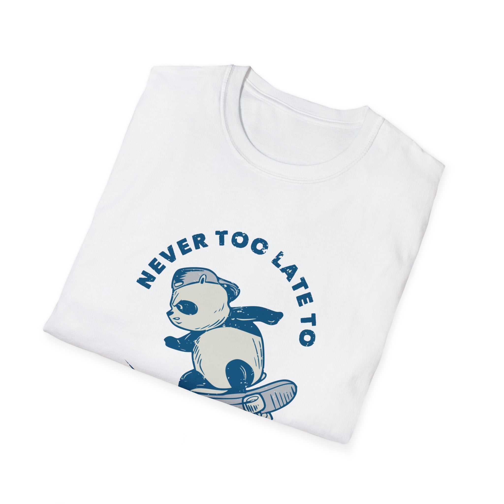 A folded white "Never Too Late to Skate" T-shirt showcases a panda on a skateboard with the phrase boldly printed in blue, embodying the passion for skating.