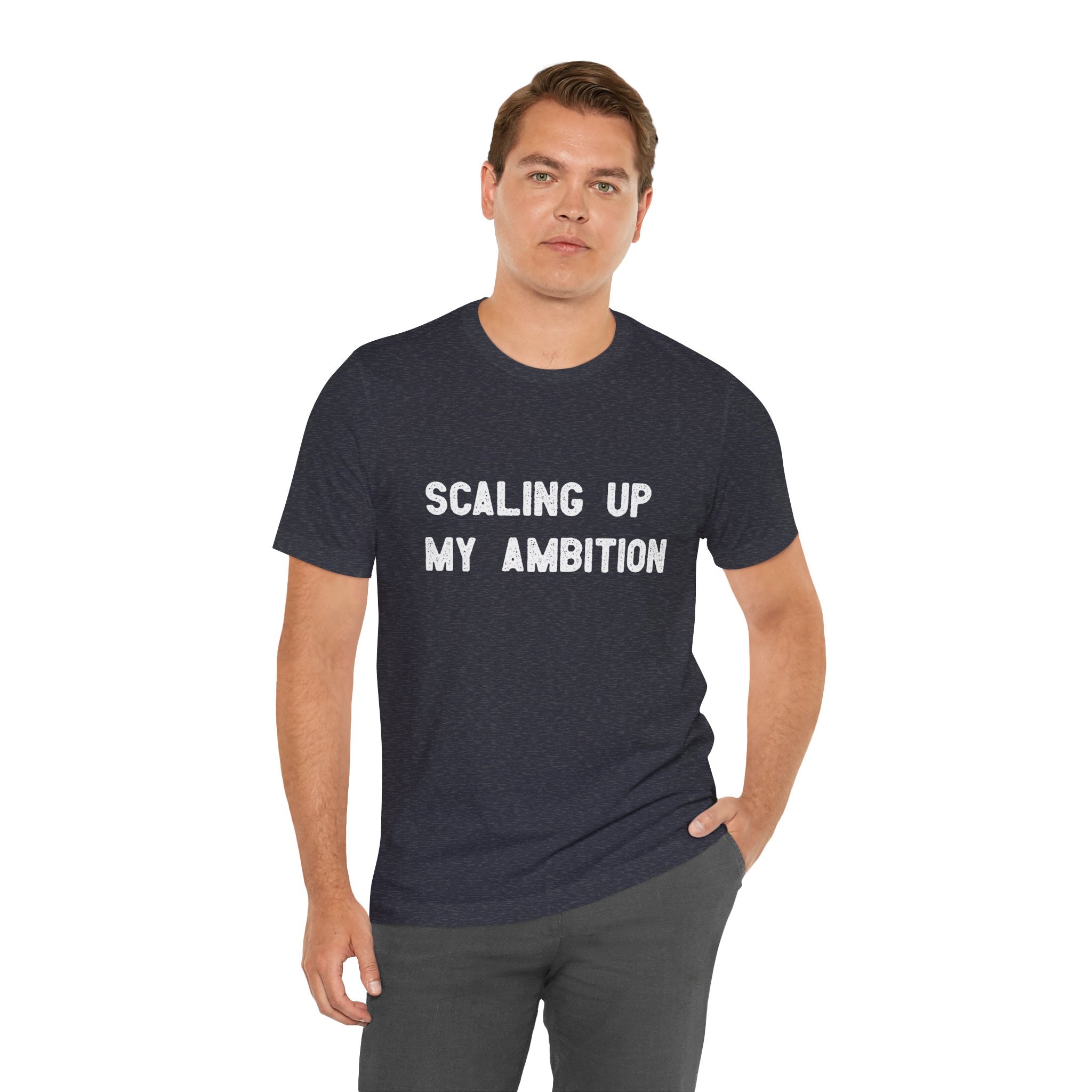 A man wearing the "Scaling Up My Ambition - T-Shirt," made from durable Airlume cotton, stands against a white background.
