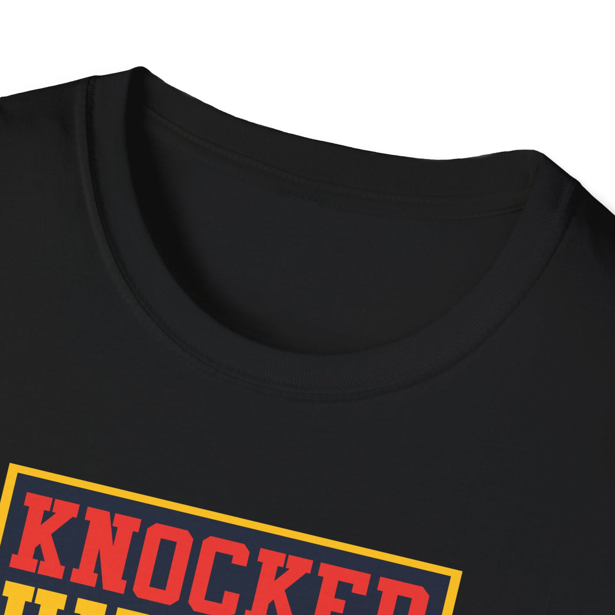 Close-up of "Knocked Him Out" robot boxing print on black t-shirt collar, retro arcade graphic detail