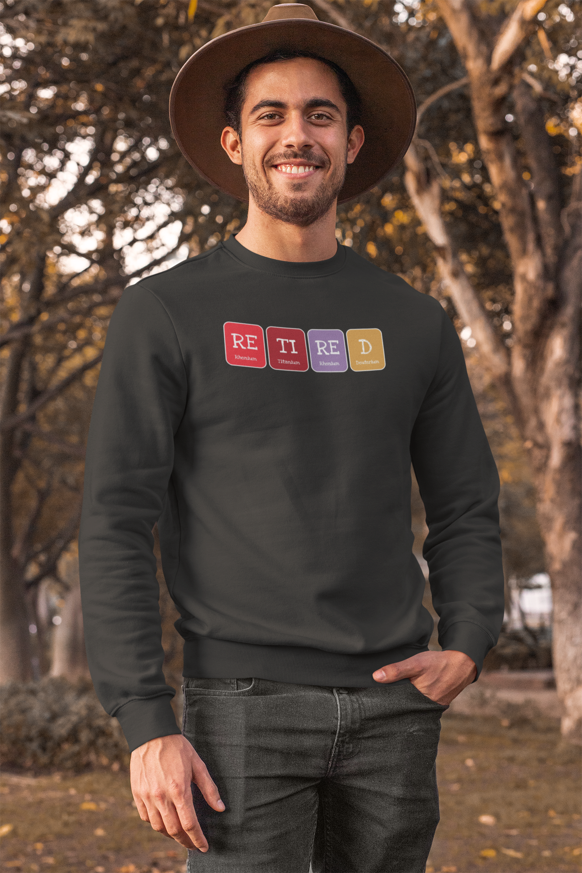 'Retired' periodic table sweatshirt in charcoal, man wearing it outdoors, funny retirement pun gift