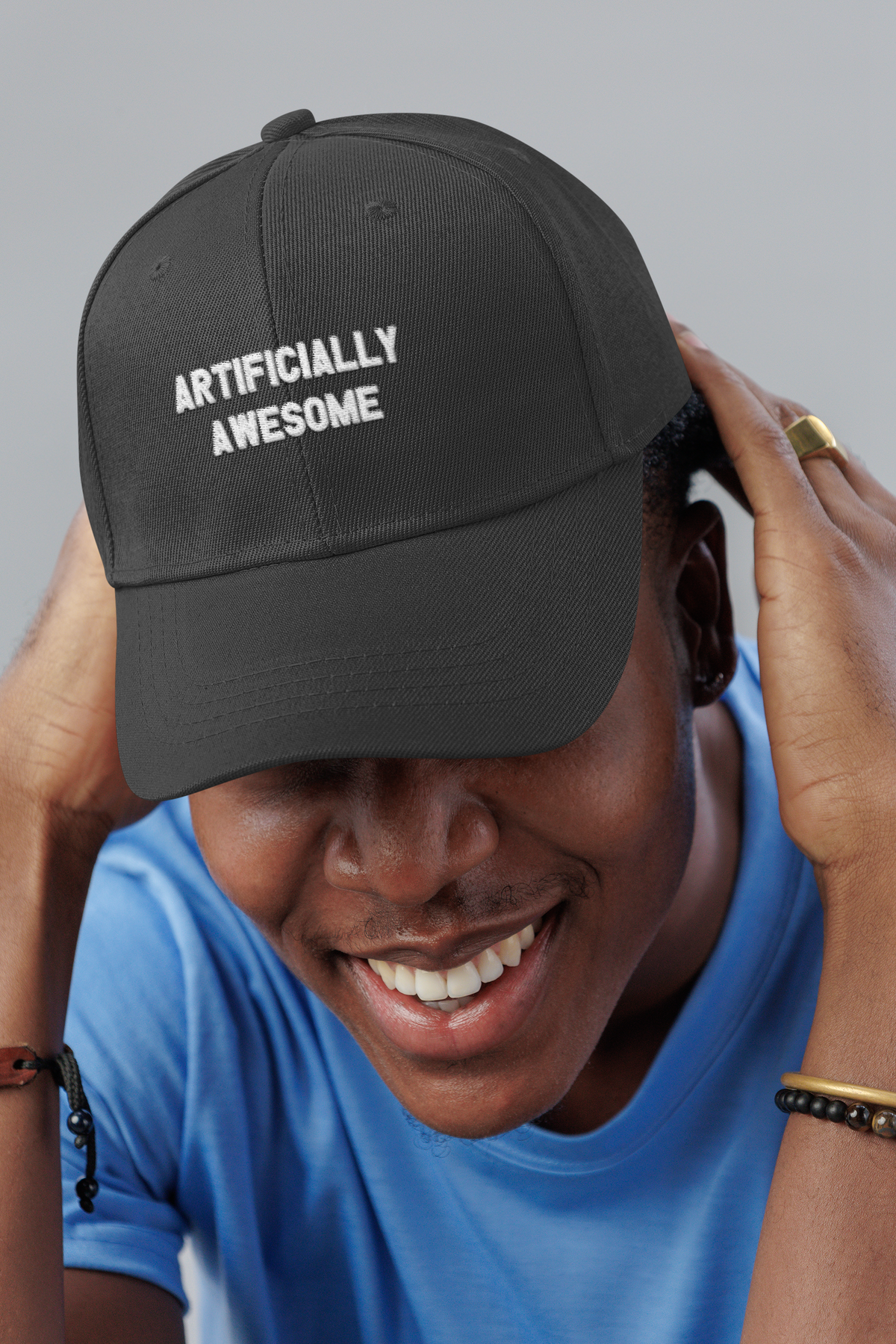 Artificially Awesome AI engineer dad hat, smiling man in a studio, lifestyle mockup, Geekpsters