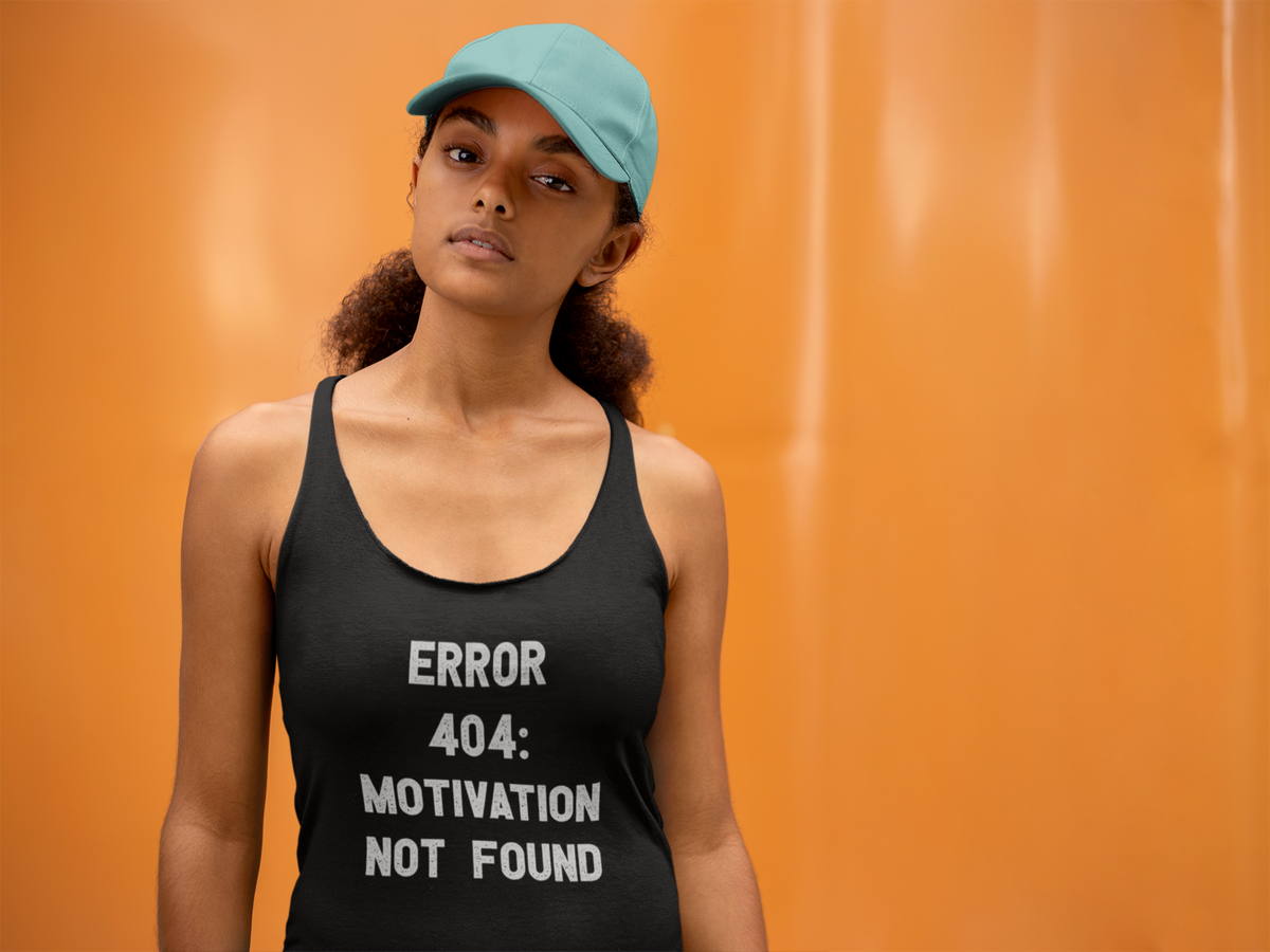 'Error 404 Motivation' racerback tank top in black, woman wearing it by an orange wall, Tank Top mockup, Geekpsters