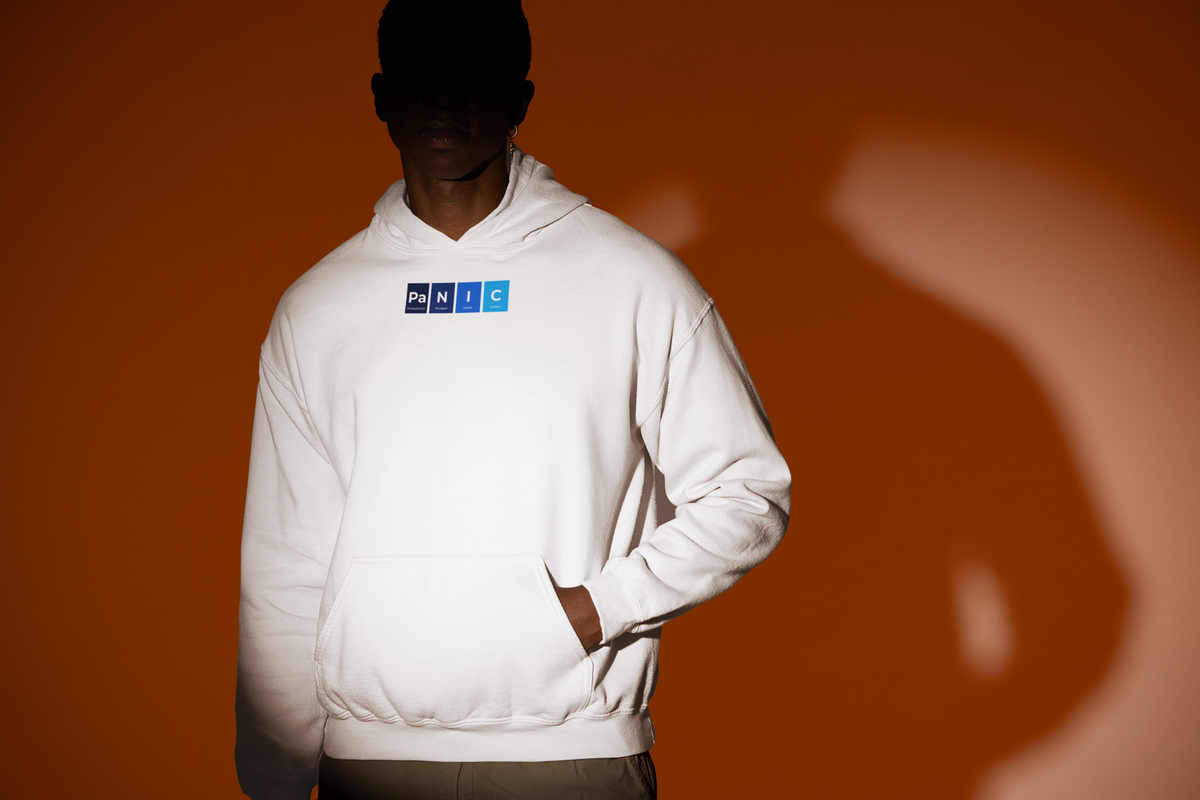'Pa-N-I-C Periodic Table Hoodie' in white, man under a spotlight, Hoodie mockup, Geekpsters