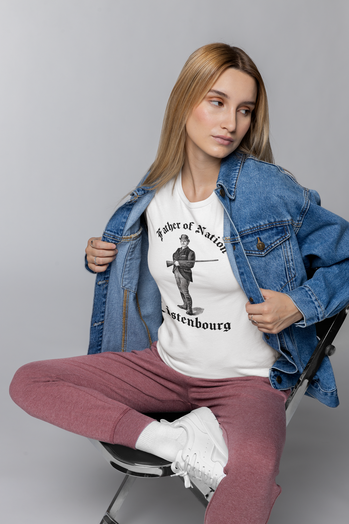 'Father of Nation Listenbourg' t-shirt in white, woman in denim jacket wearing it