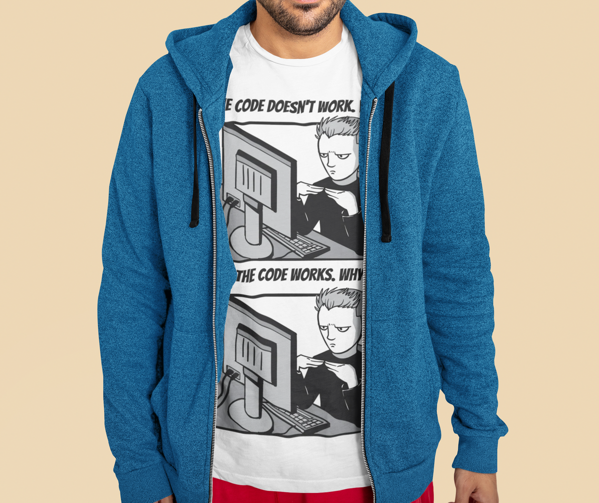 'The Code Doesn't Work, Why?' t-shirt in white, man model wearing it under a blue zip hoodie, funny coder gift