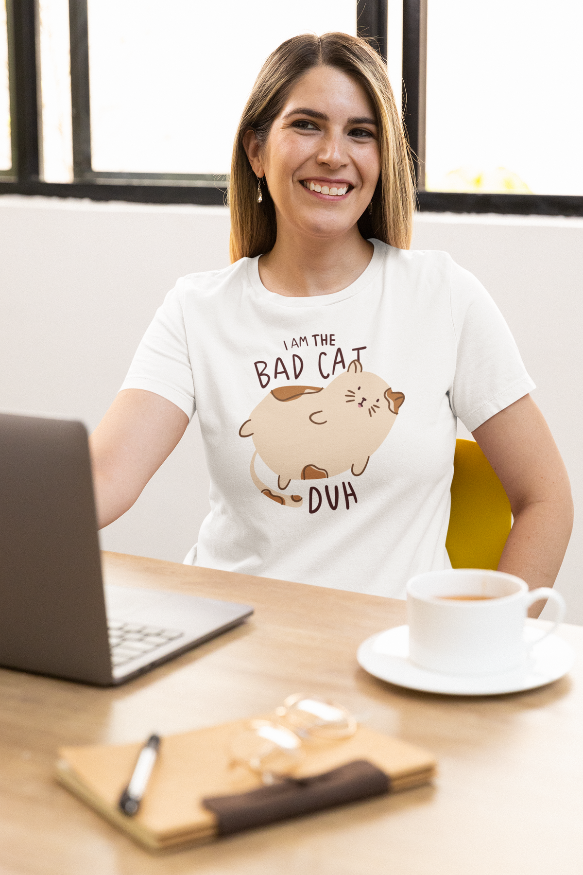 'I Am the Bad Cat Duh' T-shirt in white, woman wearing it at a desk, funny cat lover office gift