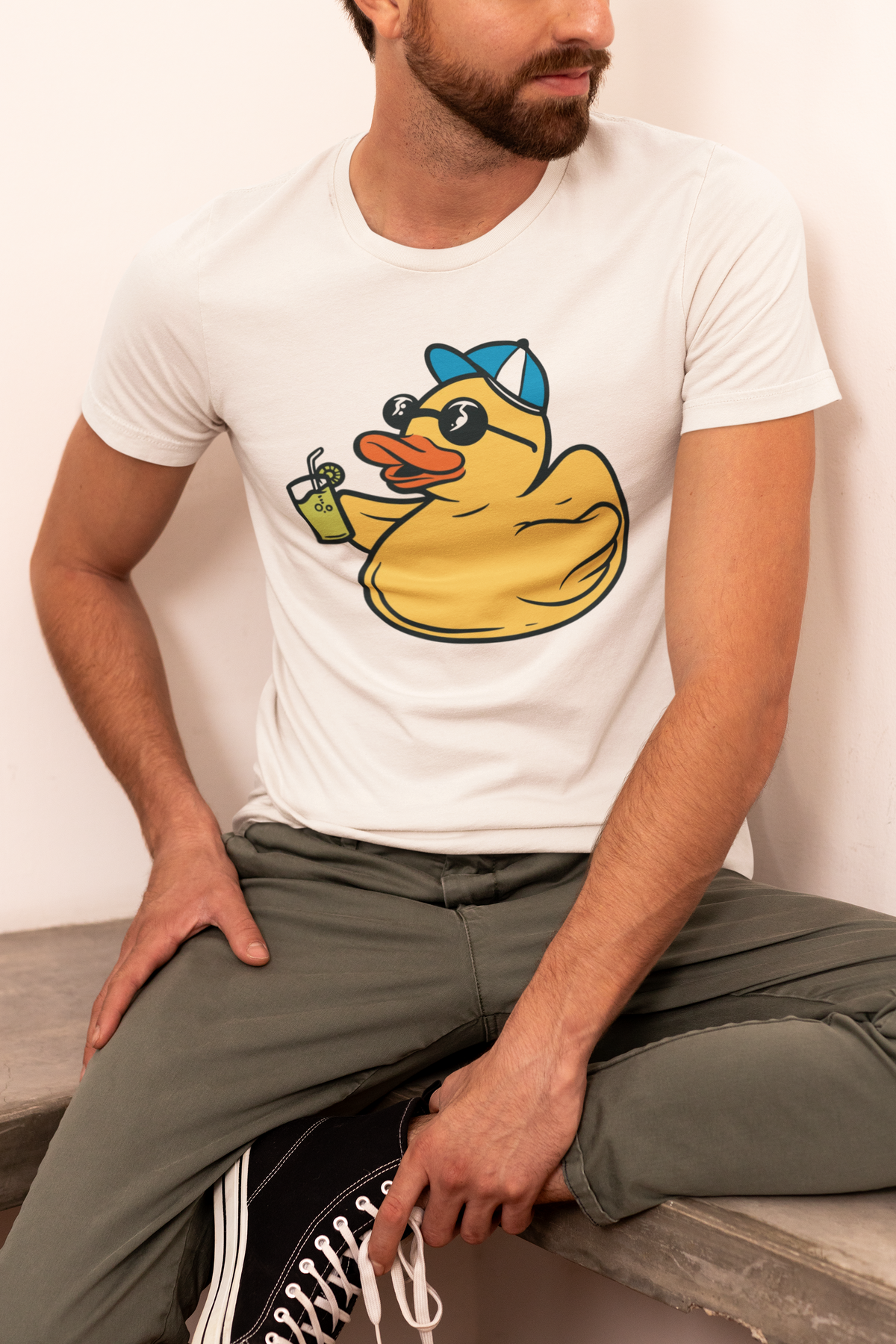 Vacation duck t-shirt in white, man model seated wearing it, funny summer gift for duck lovers