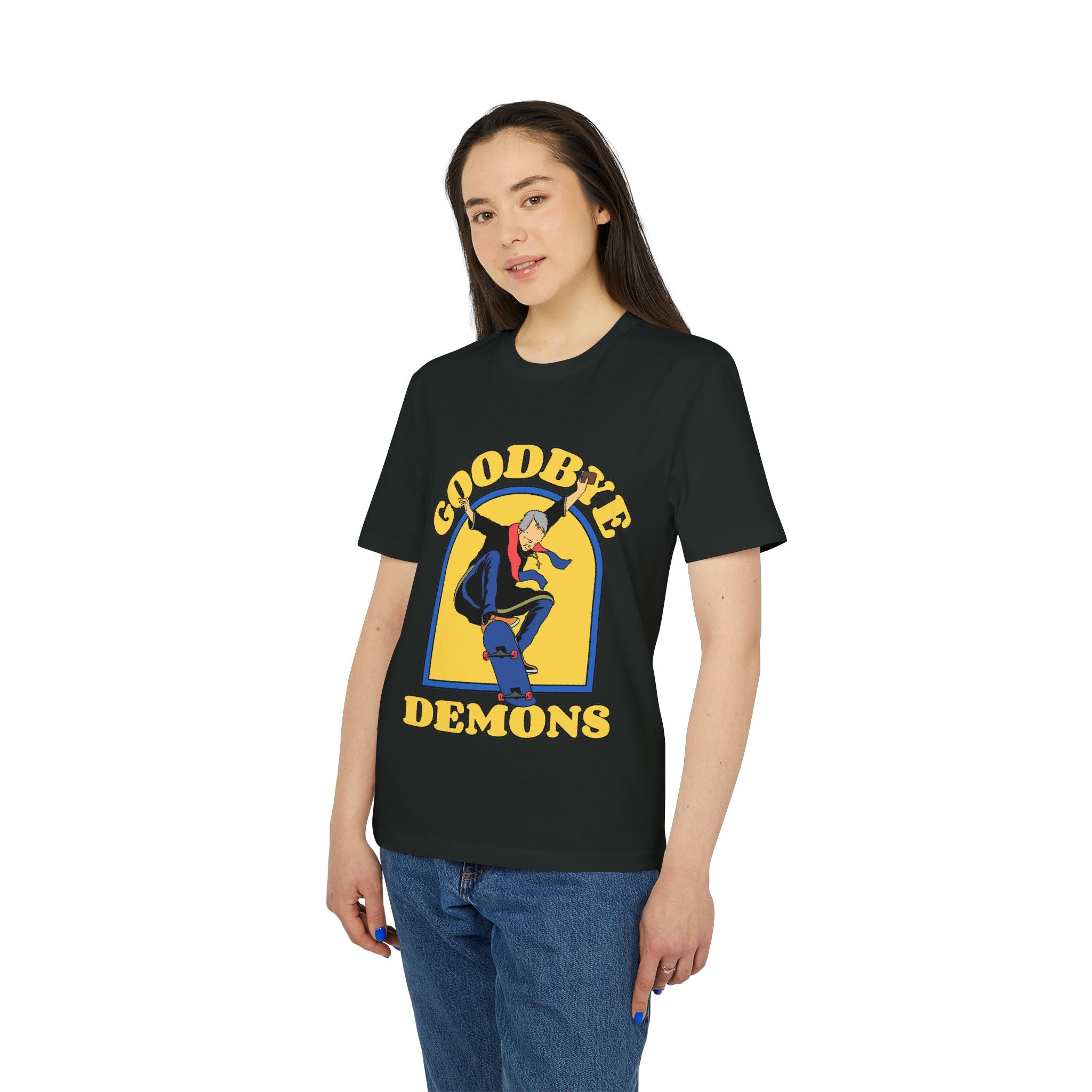 A woman faces forward wearing the "Goodbye demons - Organic T-Shirt," a black tee made from organic cotton featuring a skateboard graphic and "GOODBYE DEMONS" in yellow.