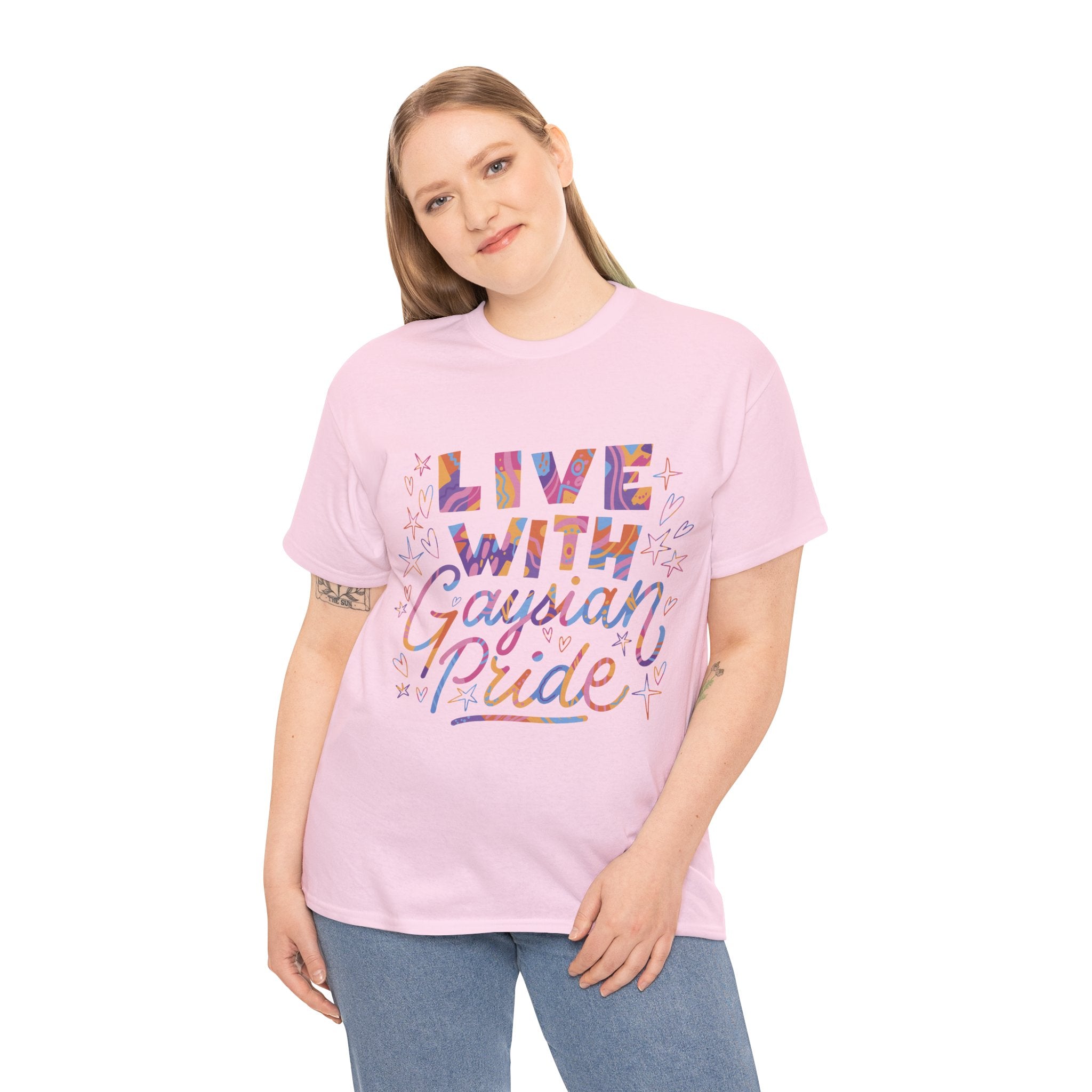 A person wears the "Live With Gaydian Pride" T-shirt, pink with decorative elements, symbolizing a celebration of identity and nerd culture, against a white background.