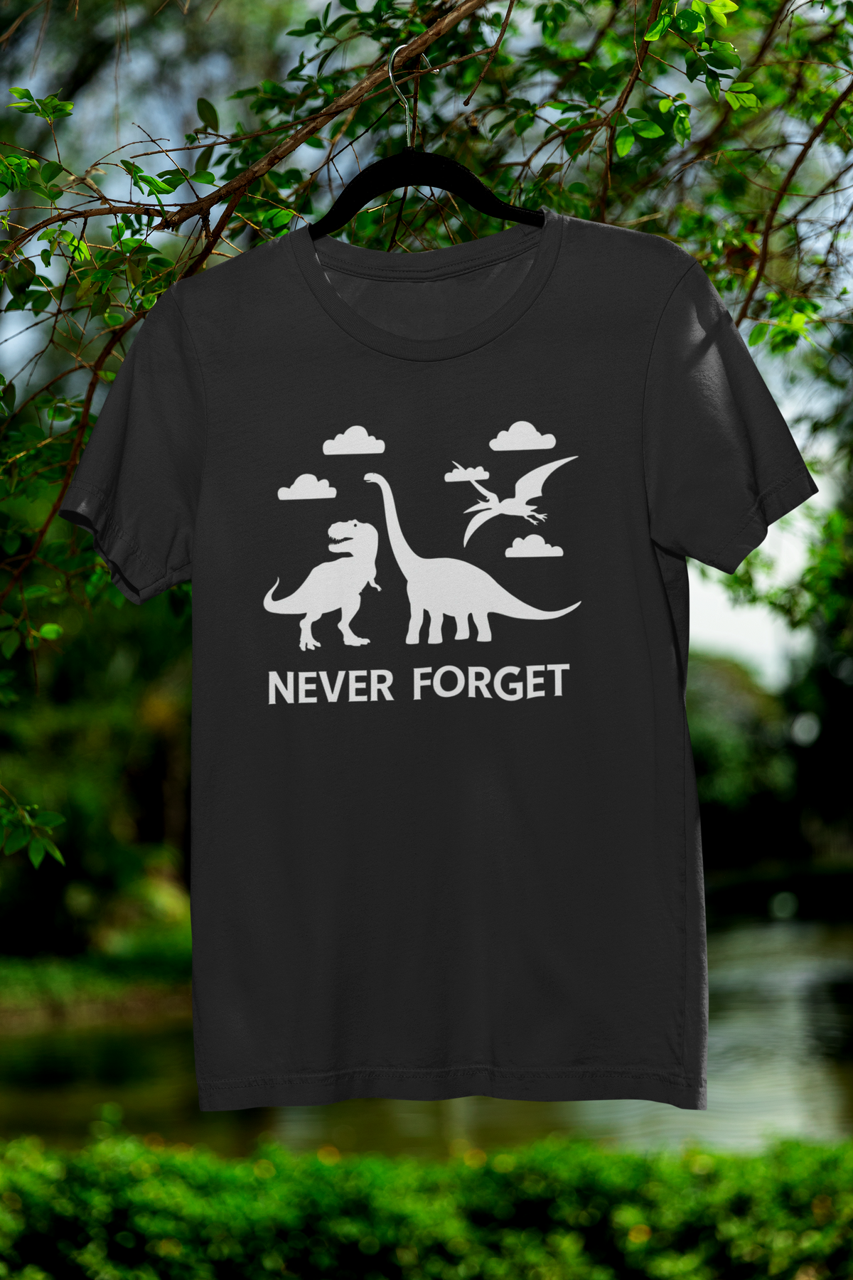 'Never Forget' dinosaur t-shirt in black, hanging outdoors in a garden, funny gift for science lovers