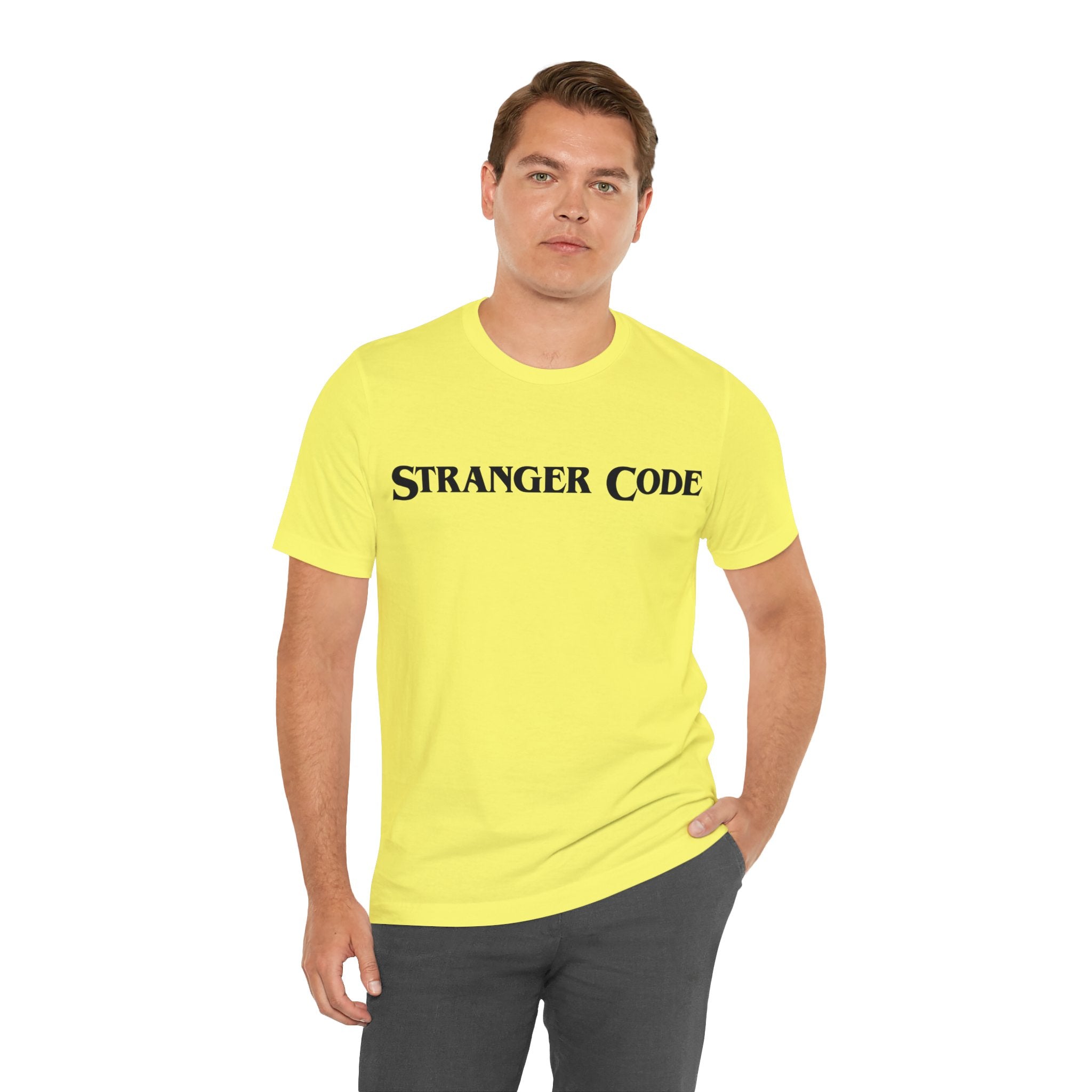Against a plain white background, someone wears the Stranger Code Tee Shirt, a classic unisex jersey tee crafted from soft cotton and adorned with the high-quality "STRANGER CODE" print.