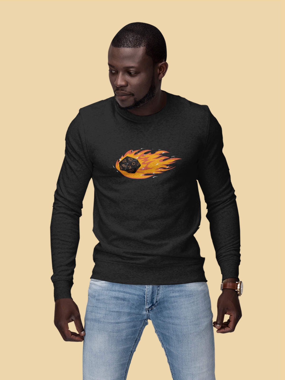 "Polyhedral Dice On Fire" sweatshirt in black, man wearing it on tan backdrop, funny tabletop gamer gift