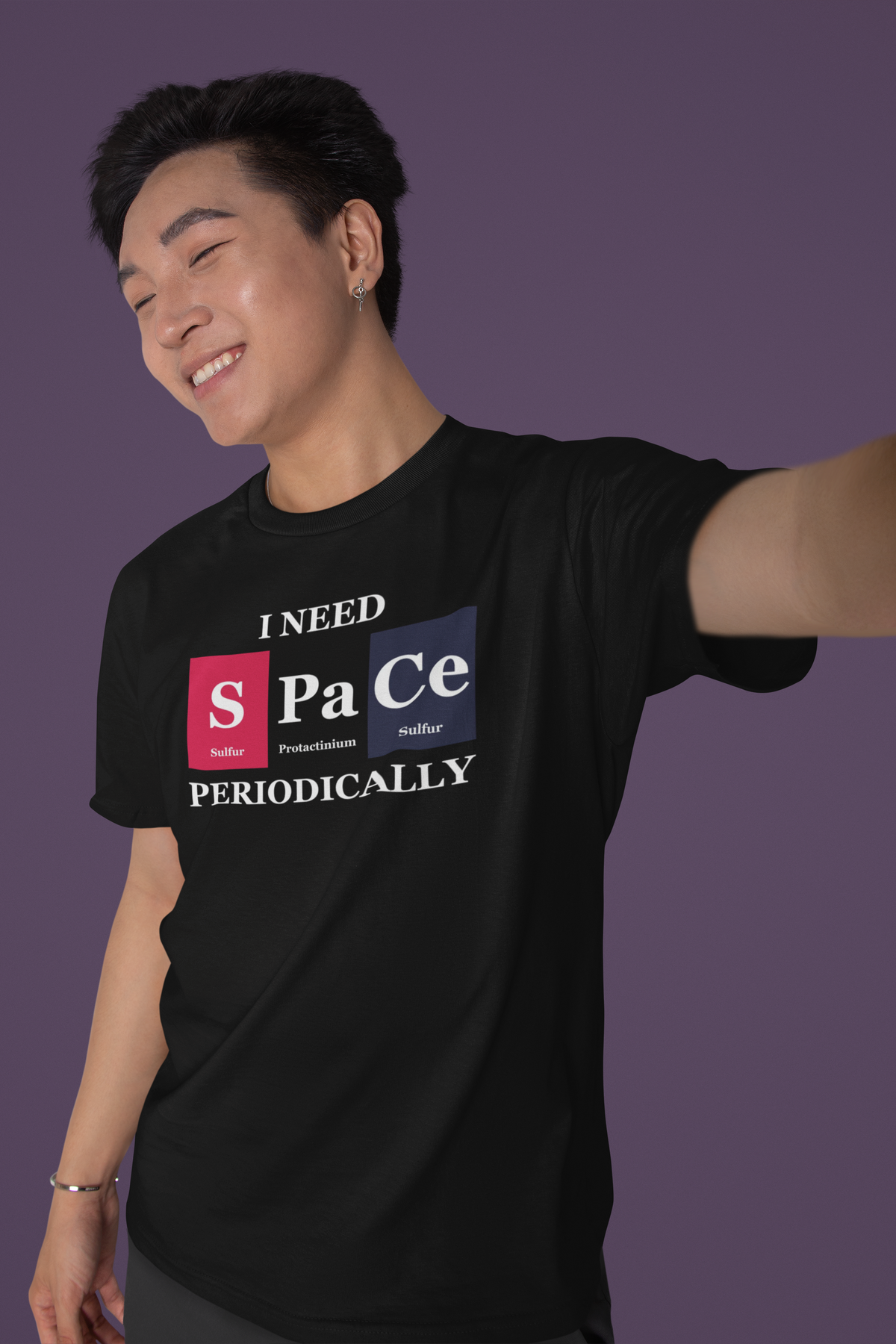 'I Need Space Periodically' periodic table t-shirt in black, smiling man posing, funny science pun tee