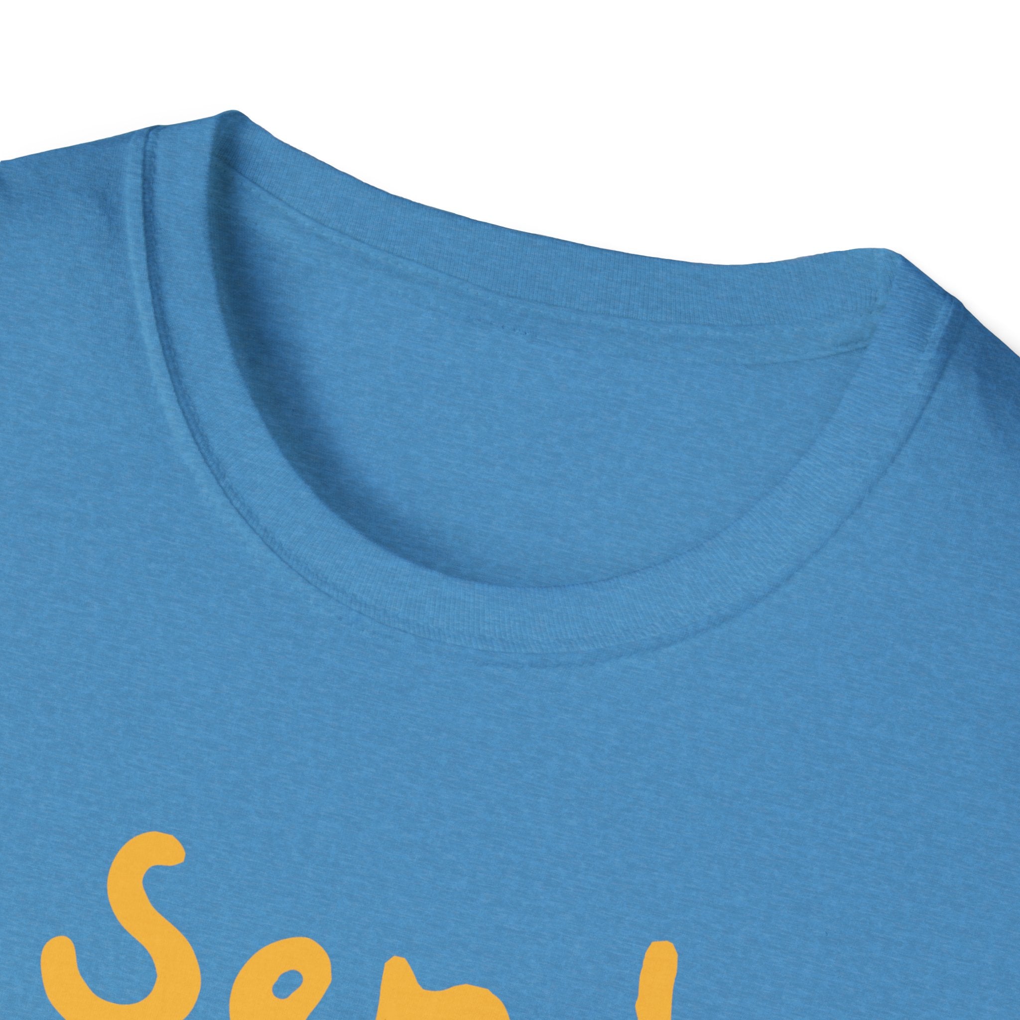 Close-up of a trendy blue T-shirt with the partial phrase "Send" displayed in bold yellow letters, suggesting humor or playfulness.
