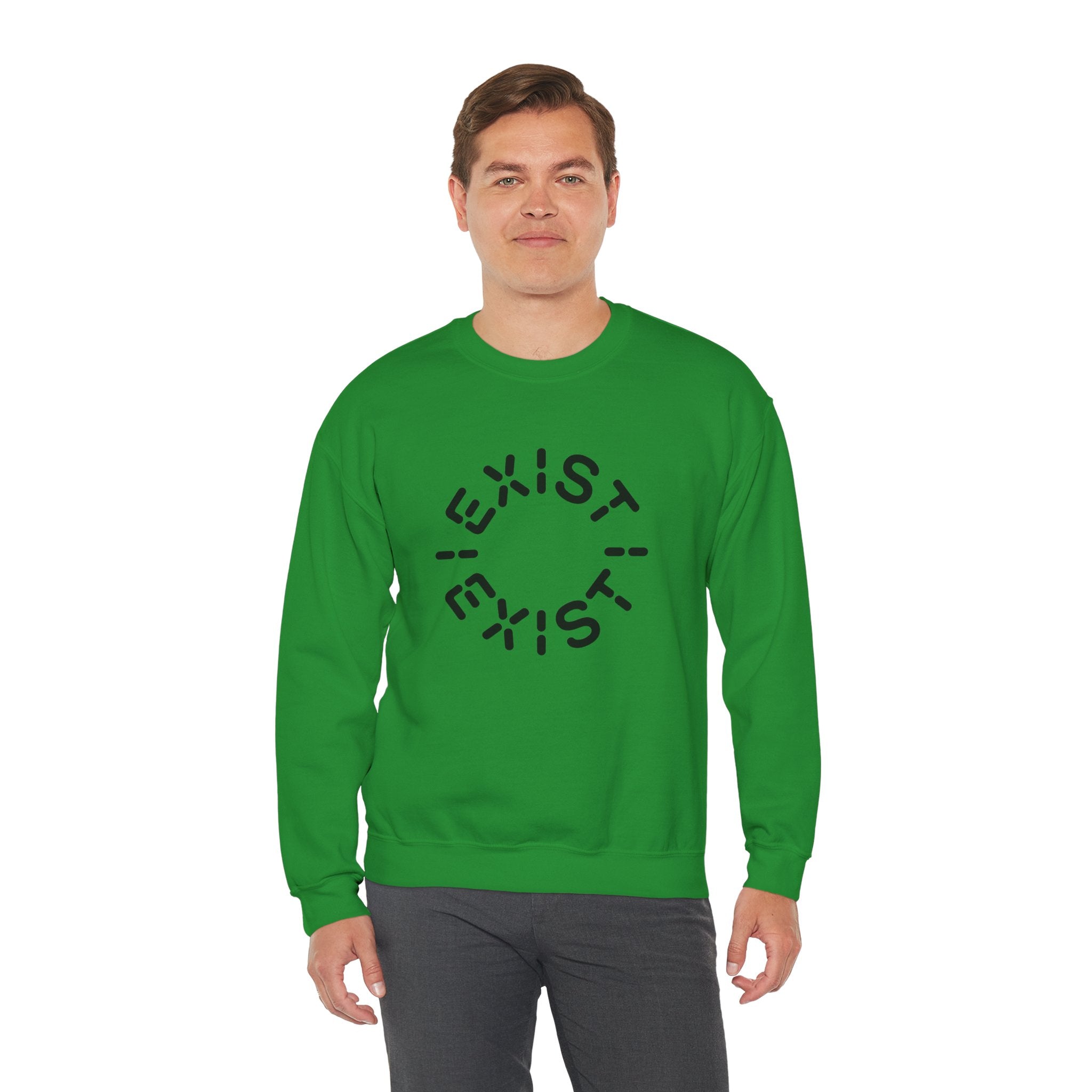A man wears the Exist Exist - Sweatshirt, an eco-friendly green top featuring “EXIST” in a circular black print on the front.
