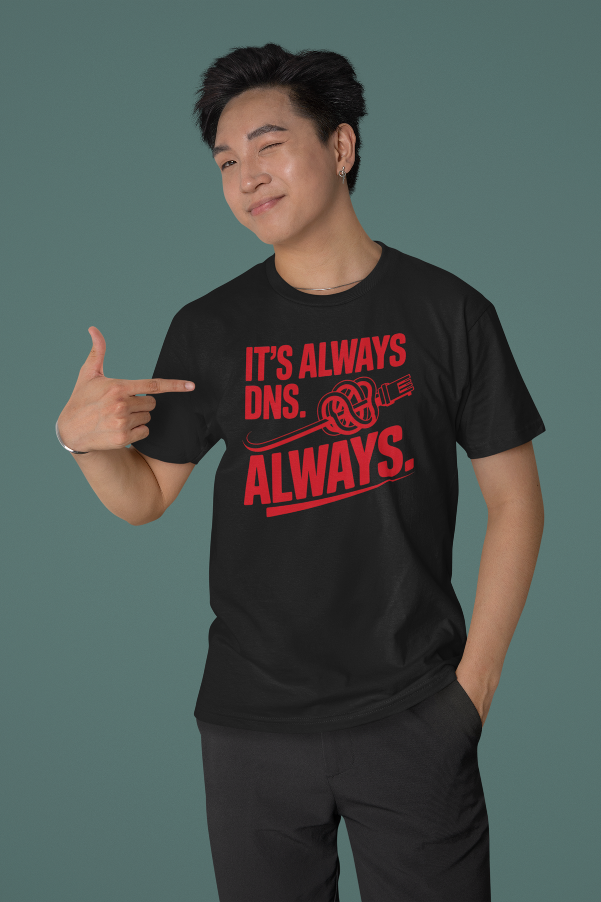 'It's Always DNS. Always.' black oversized tee worn by man pointing, funny gift for IT professionals