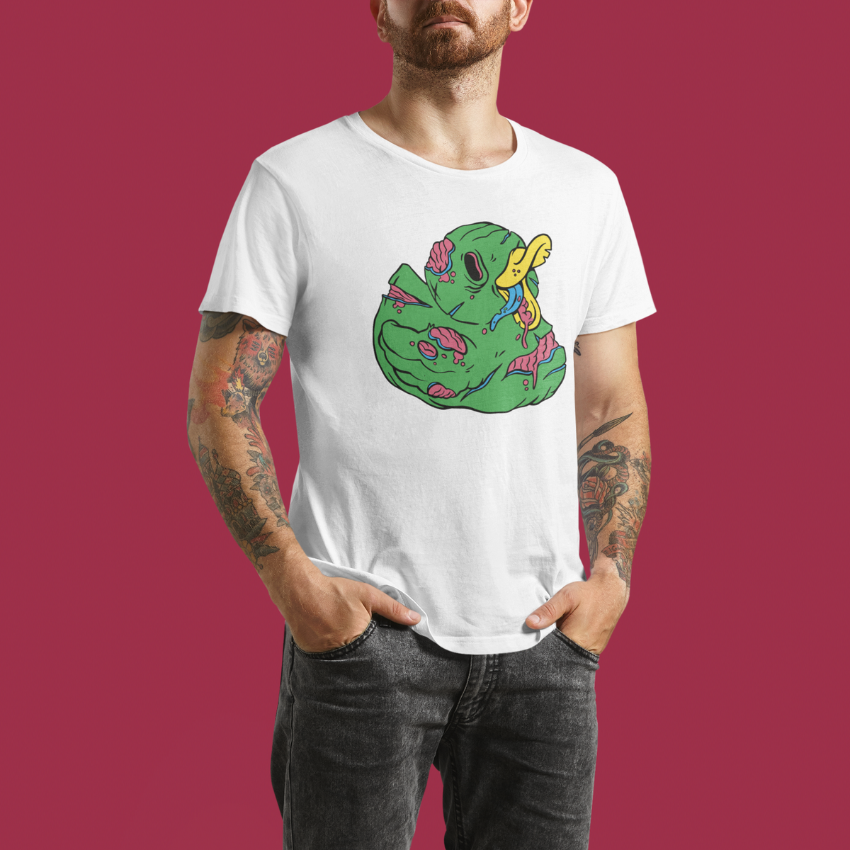 Zombie duck t-shirt in white, tattooed man model wearing it against a maroon background, funny halloween duck gift