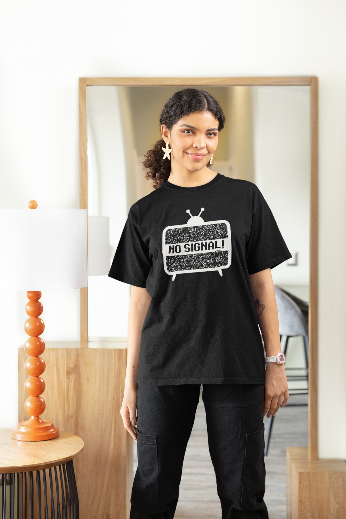 'No Signal' women's fitted t-shirt in black, woman wearing it oversized at home, cozy retro TV gift