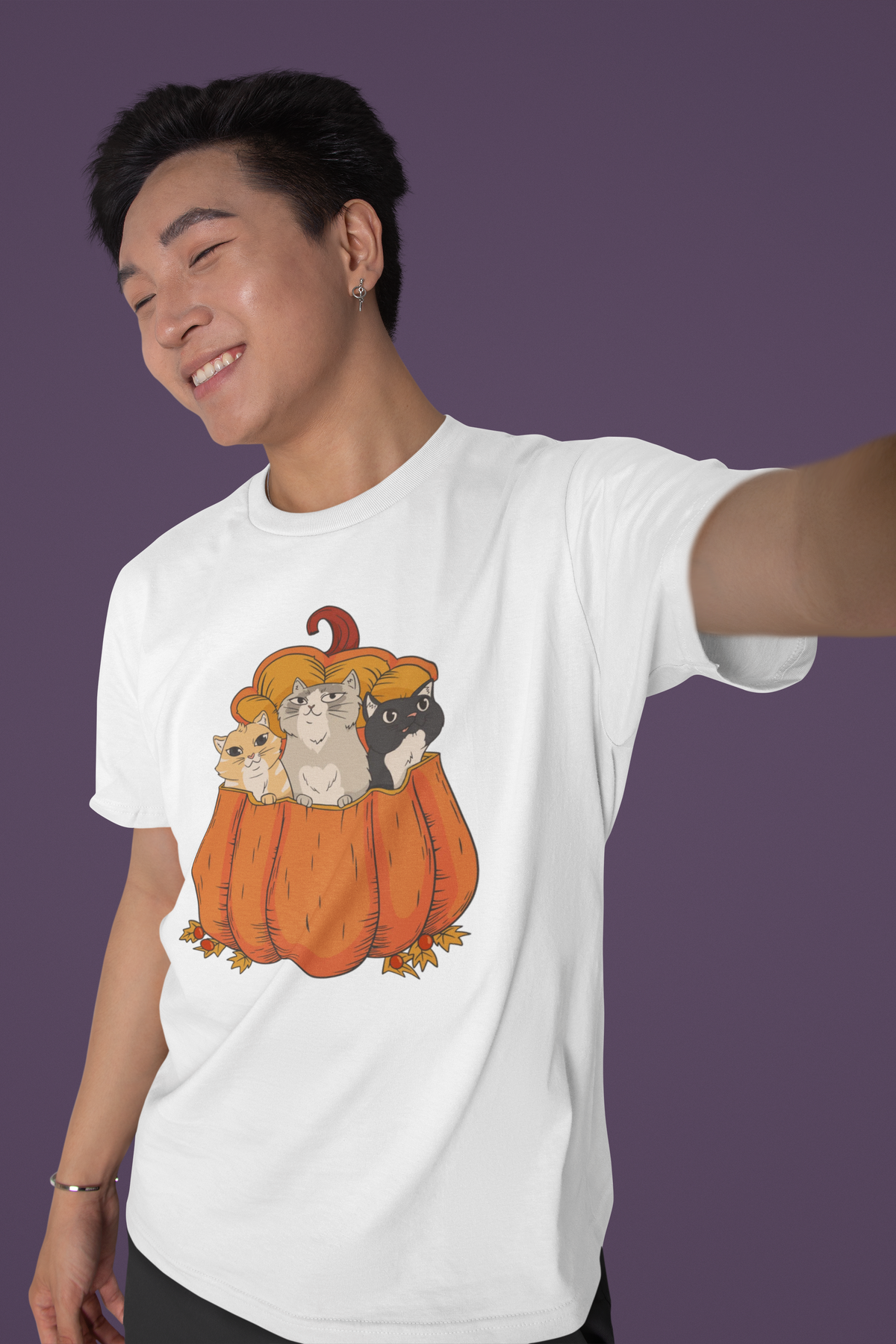 Halloween Cats in a pumpkin T-shirt in white, man wearing it against a purple backdrop, funny cat gift
