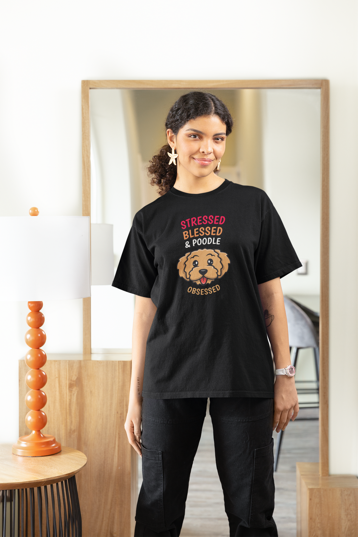 'Stressed Blessed & Poodle Obsessed' women's t-shirt in black, woman wearing it, dog lover gift