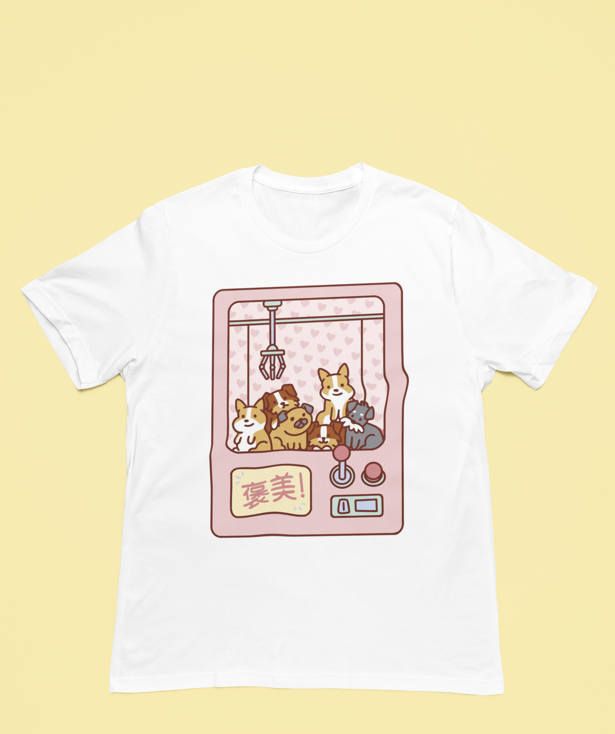Cute Claw Machine Dogs T-shirt in white, flat lay on a yellow backdrop, cute dog lover gift shirt