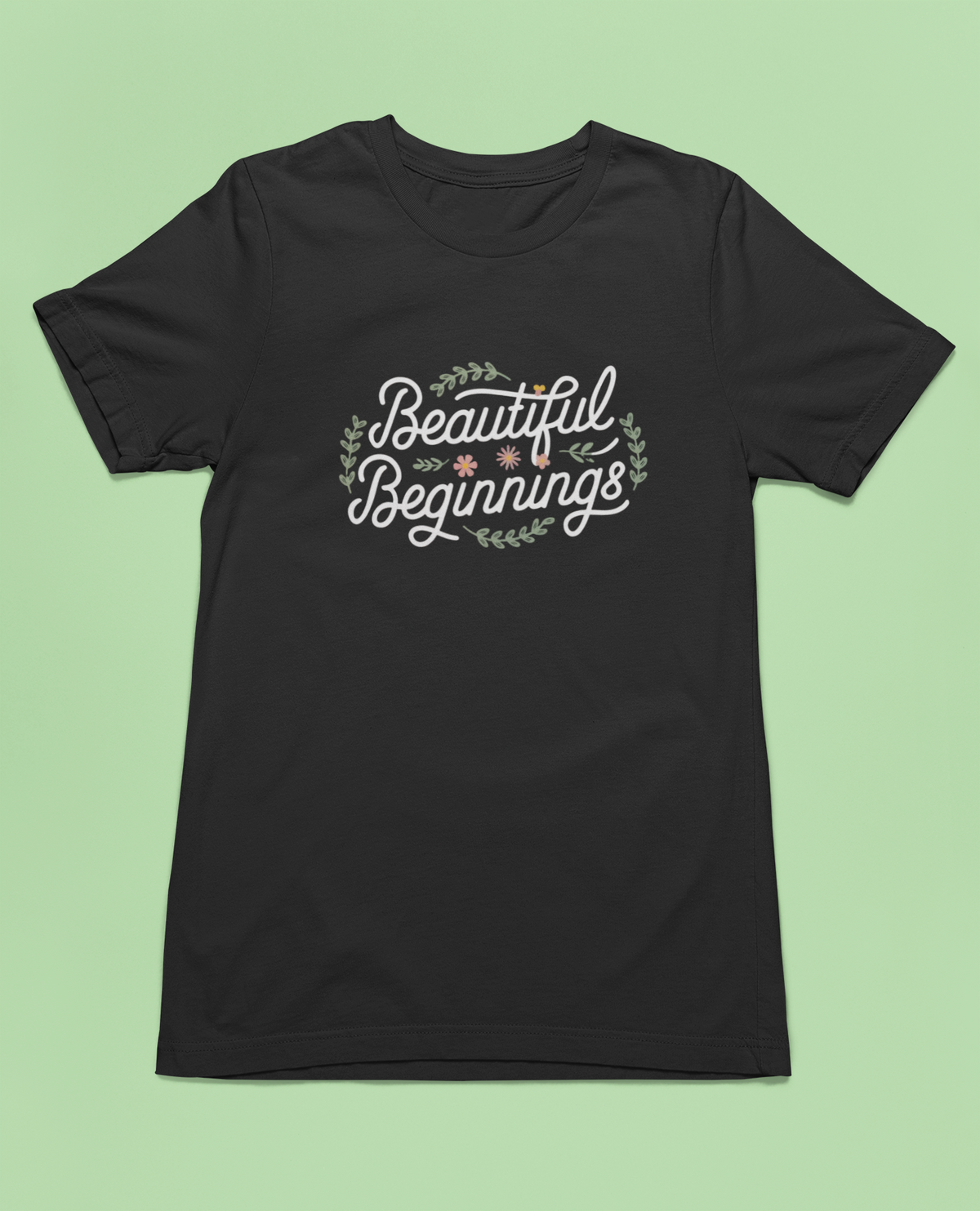 Beautiful Beginnings black t-shirt folded flat lay on green background, funny gift for new starts