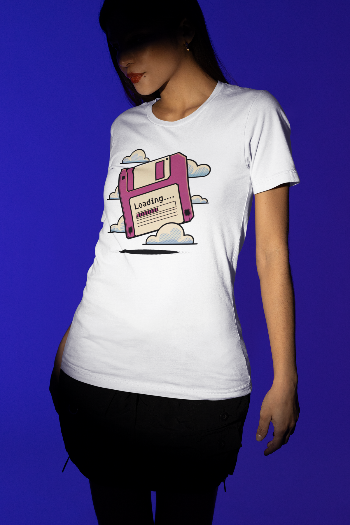 'Floppy Disk Loading' t-shirt in white, woman wearing it on blue background, funny nostalgic geek gift