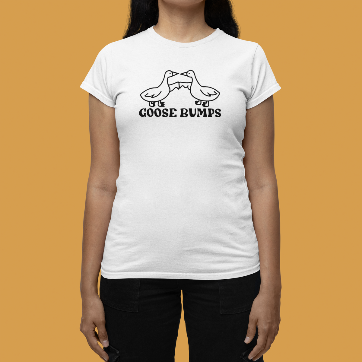 "Goose Bumps" women's tee in white, woman wearing it on mustard background, funny pun gift tee