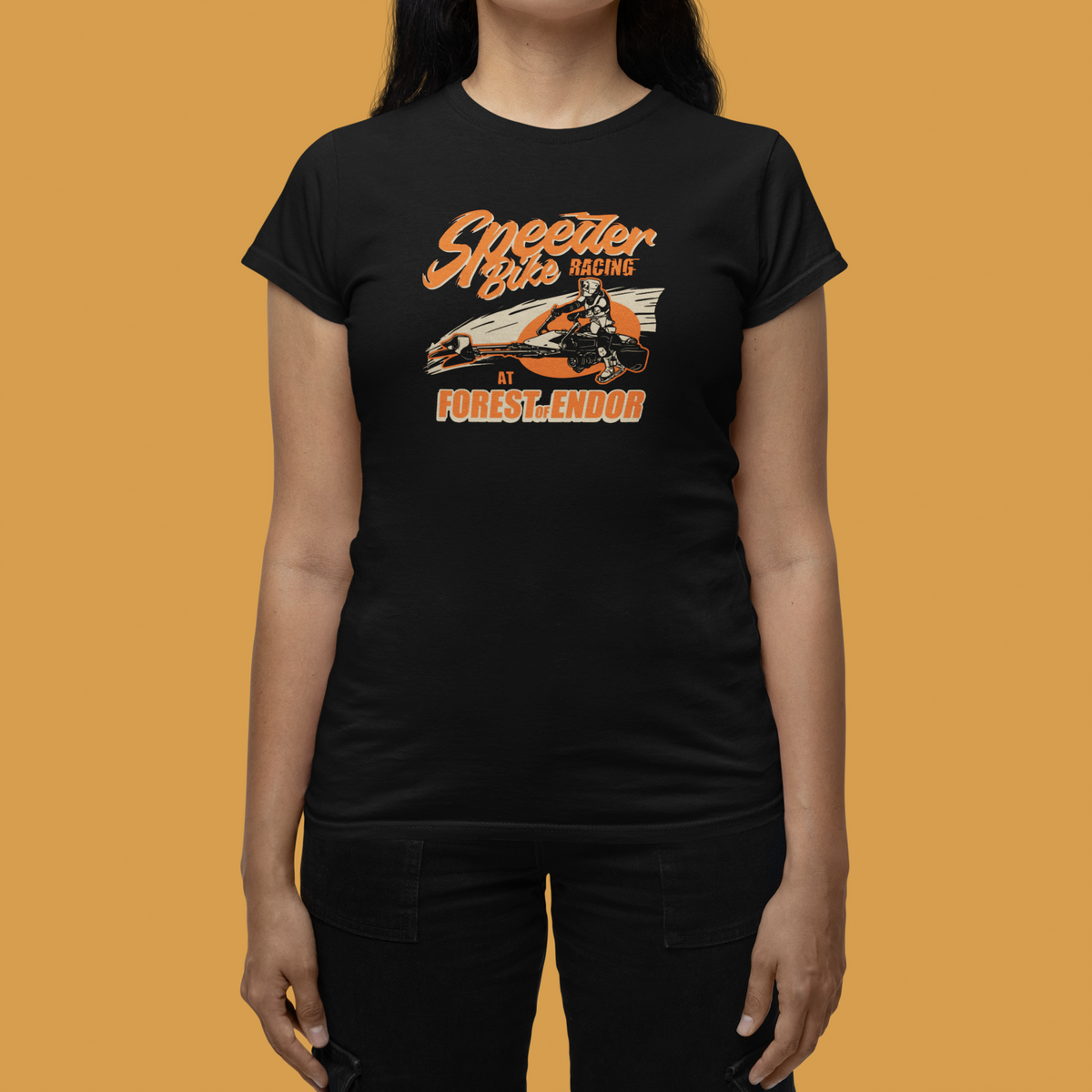 'Speeder Bike Racing' Forest of Endor t-shirt in black, woman on mustard background, funny sci-fi tee