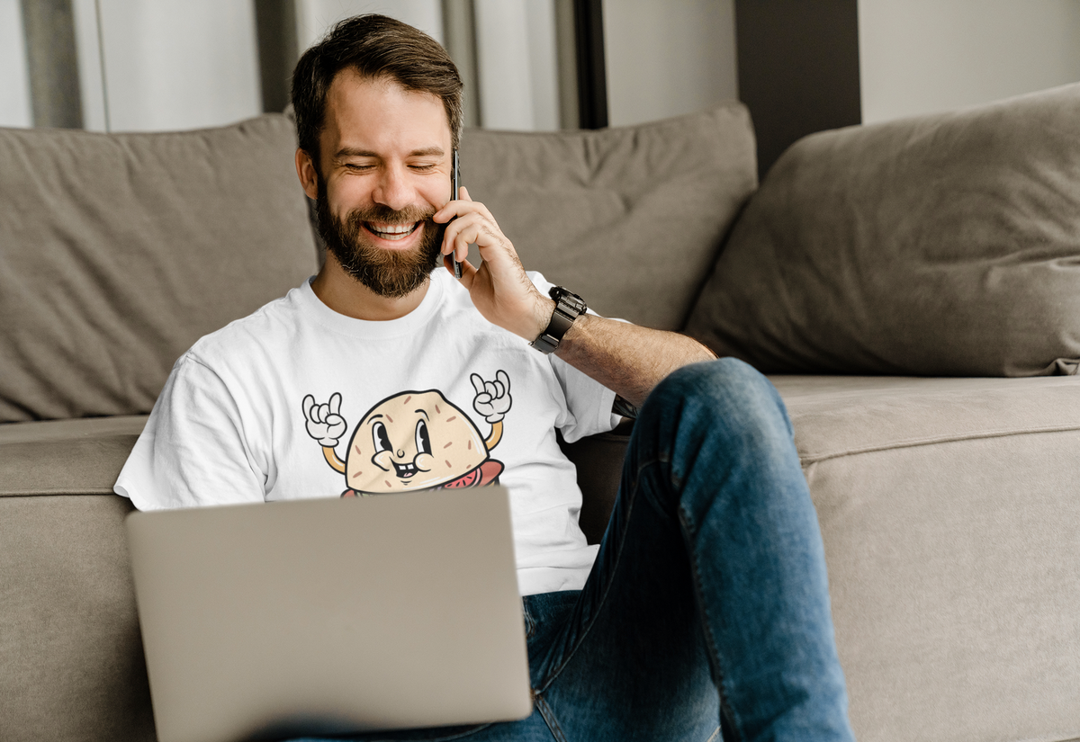 Cartoon burger t-shirt in white, man wearing it on a couch with laptop, funny gift for burger lovers