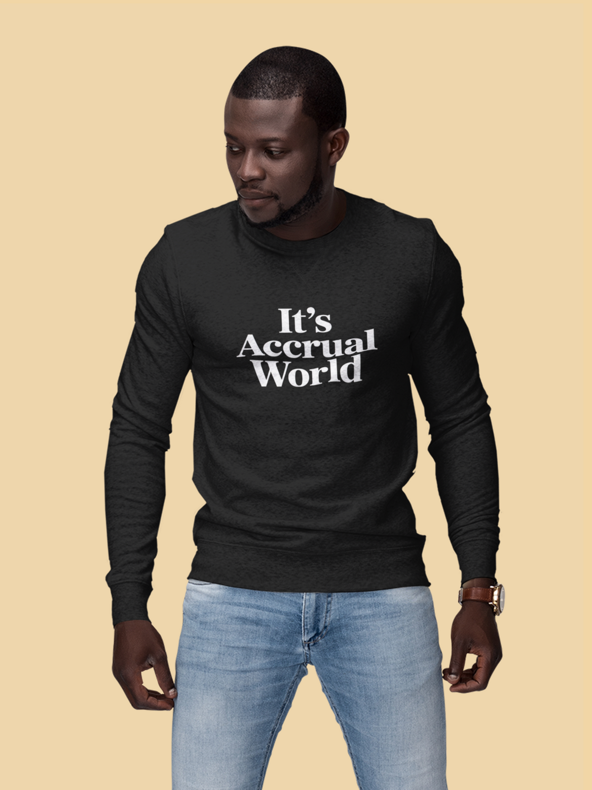 'It's Accrual World' sweatshirt in black, man wearing it on tan background, funny gift for accountants