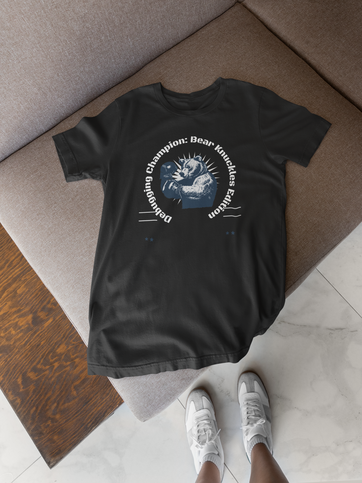 'Debugging Champion' bear graphic t-shirt in black, laid flat on floor, funny programmer tee gift