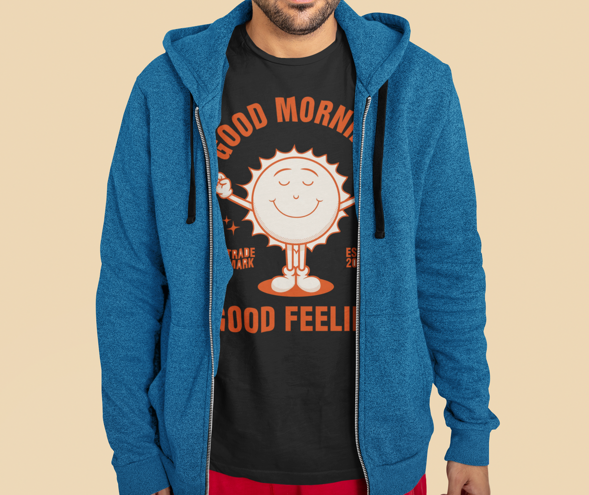 'Good Morning Good Feeling' t-shirt in black, man in a blue hoodie wearing it, uplifting gift shirt