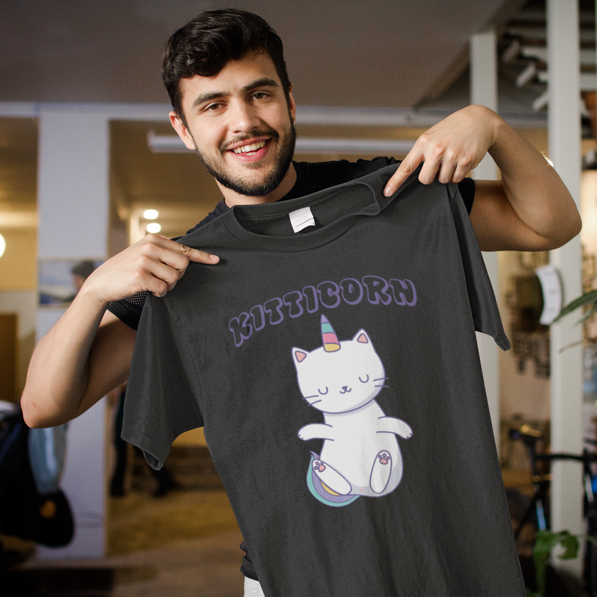 'Kitticorn' cat unicorn mashup T-shirt in black, man showing it off outdoors, funny cat lover gift tee