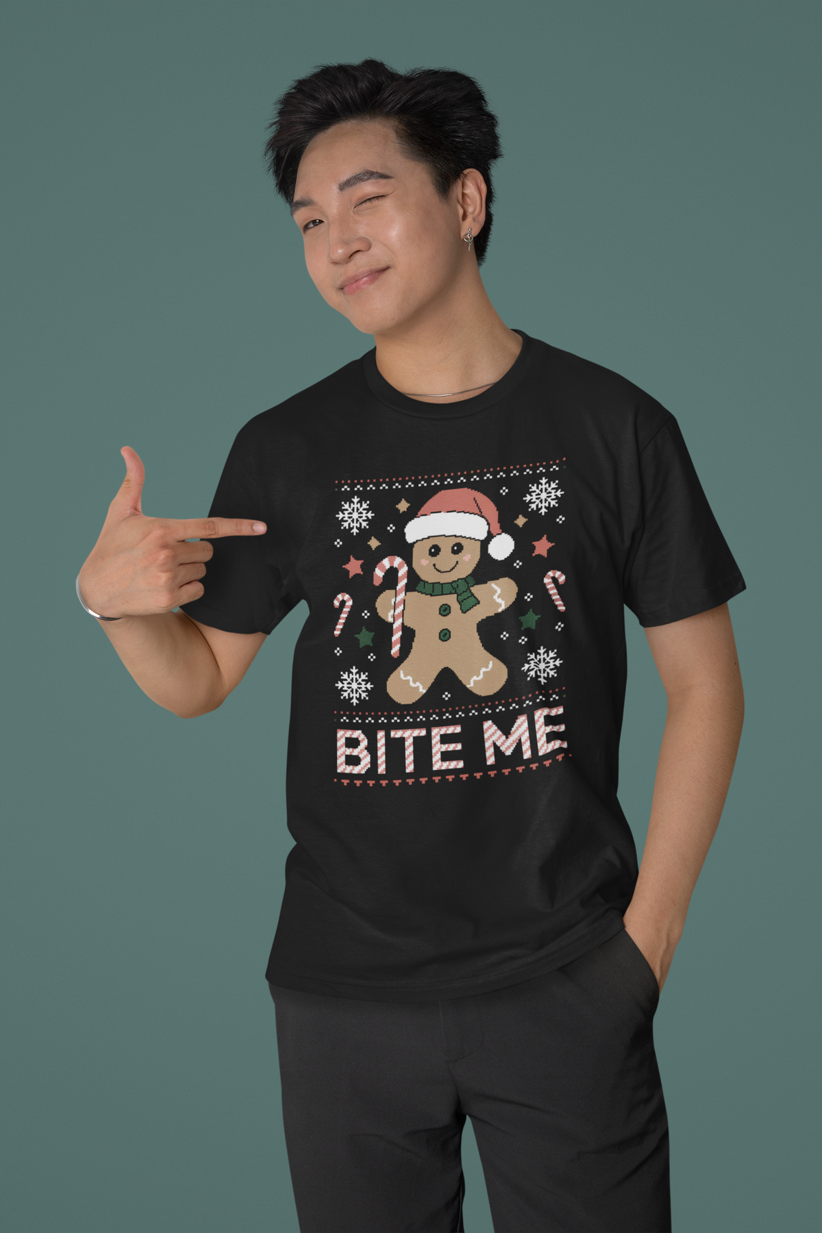'Bite Me' gingerbread man t-shirt in black, smiling man wearing it, funny Christmas pun gift shirt